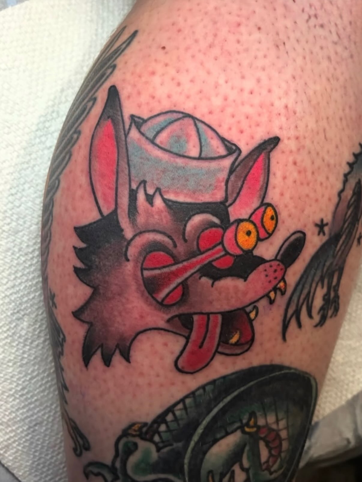 Wolf with rose hat American traditional tattoo on the forearm by Joey Knuckles