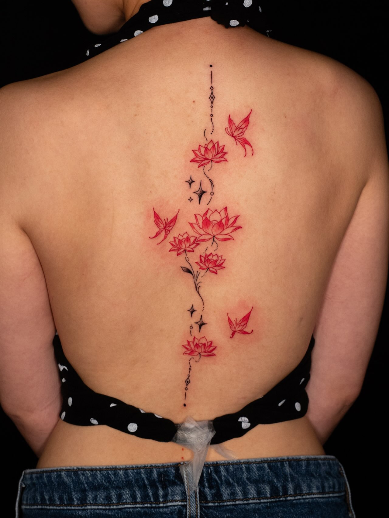 Lotus flowers and butterflies dotwork tattoo on the back by Saint Jimmy