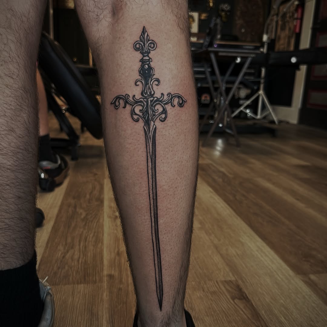 Sword black and grey tattoo on the calf by Kaylee Castleton, Tooele, Utah