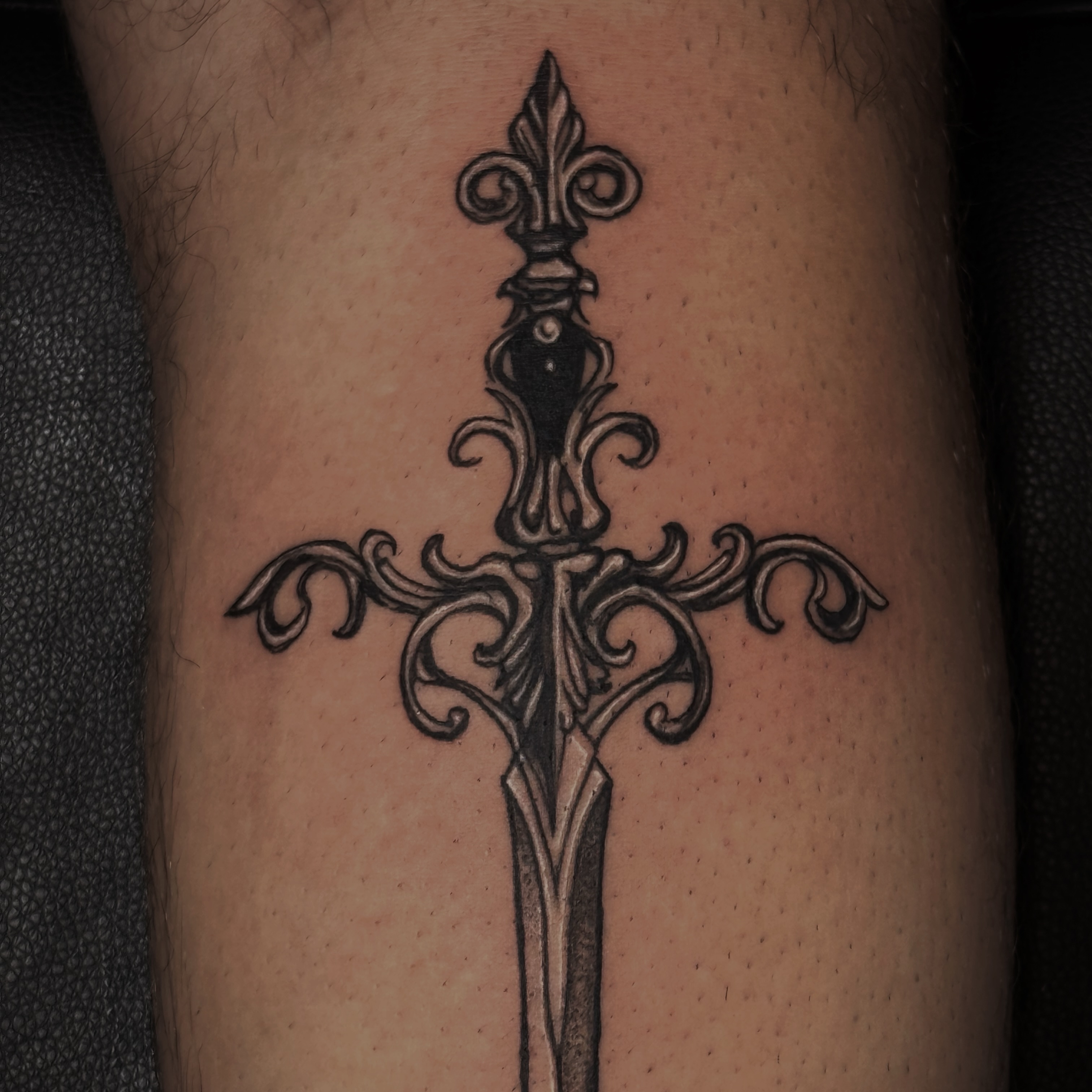 Sword black and grey tattoo on the forearm by Kaylee Castleton, Tooele, Utah