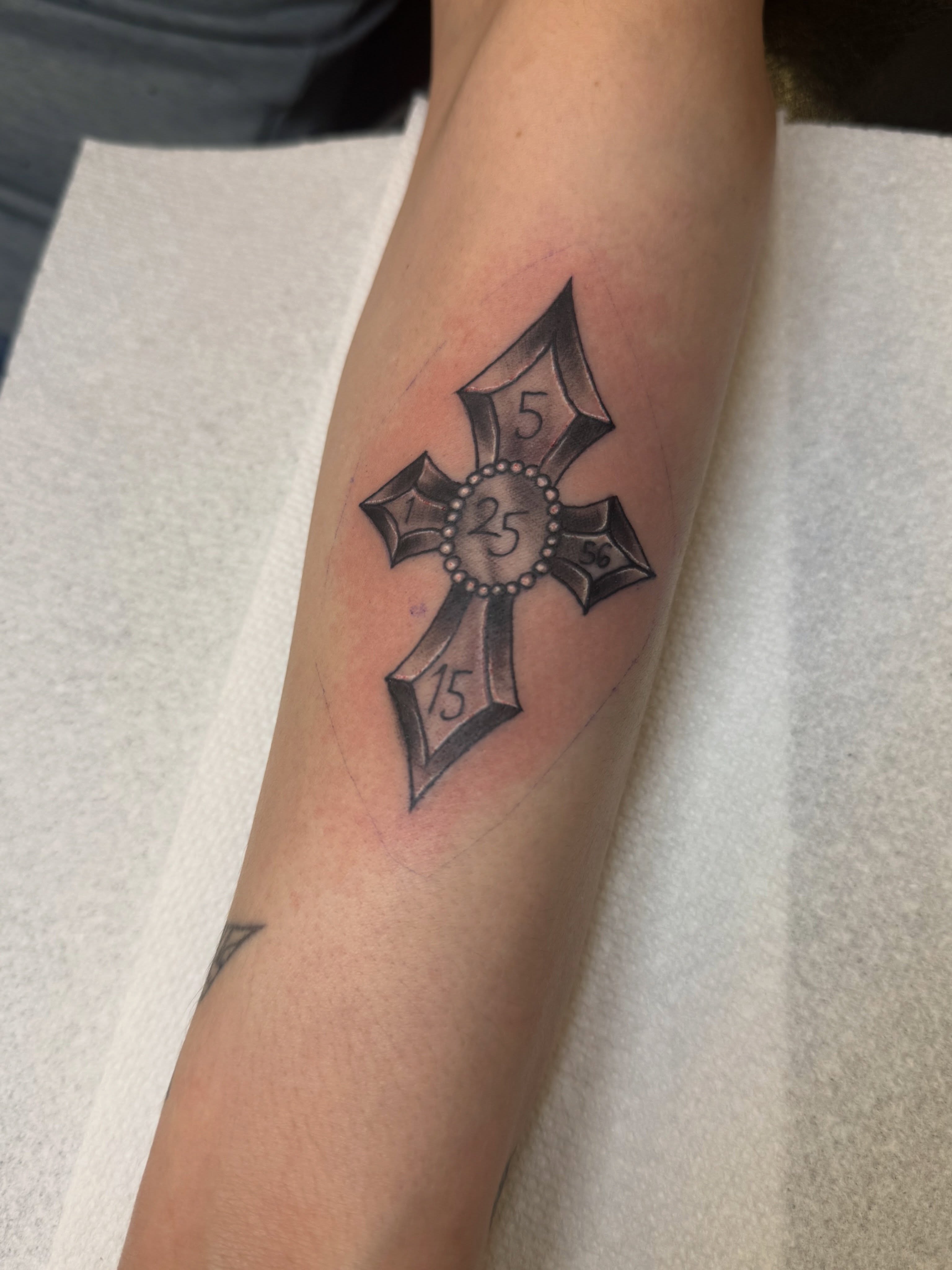 Cross black and grey tattoo on the forearm by Israel Jacob Woehler