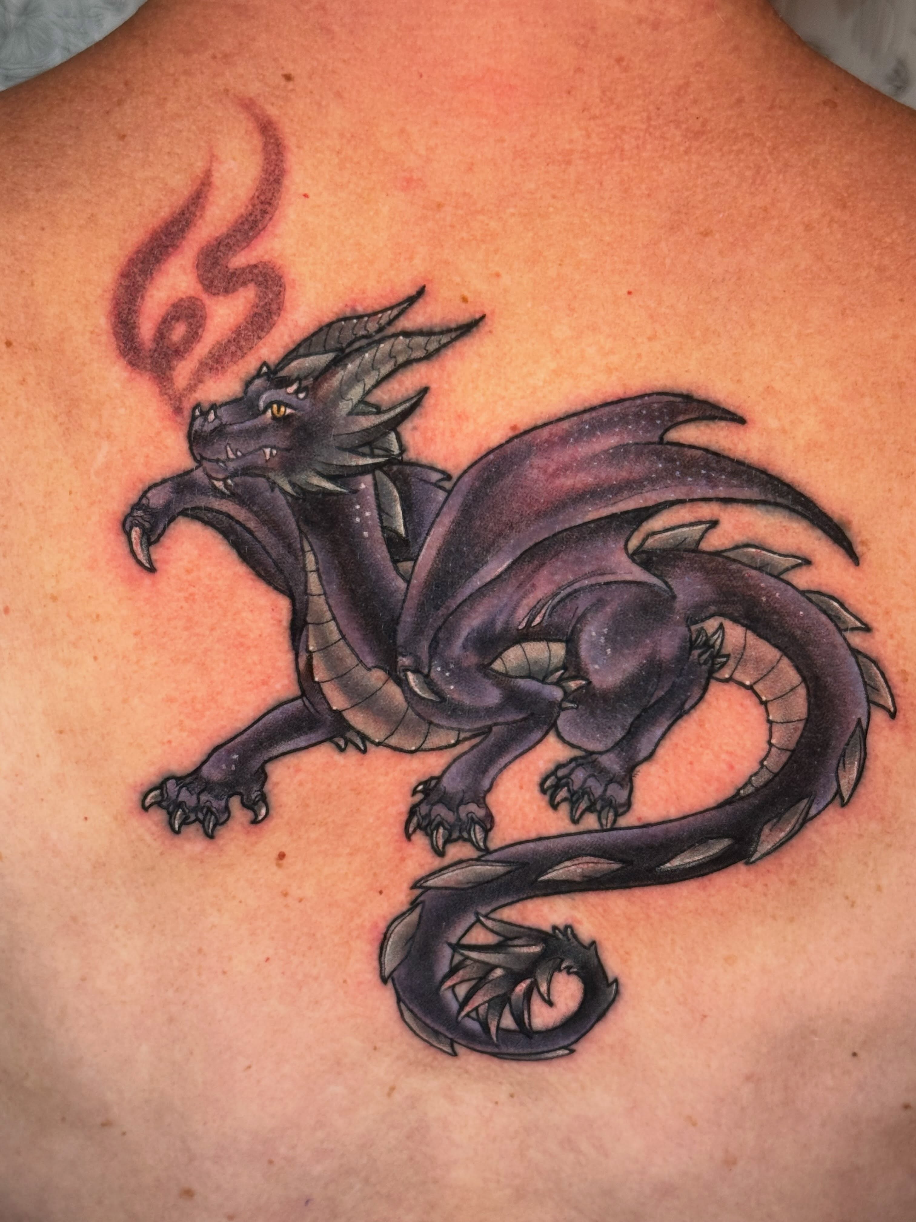 Dragon dark realism tattoo on the back by Kayla Warren