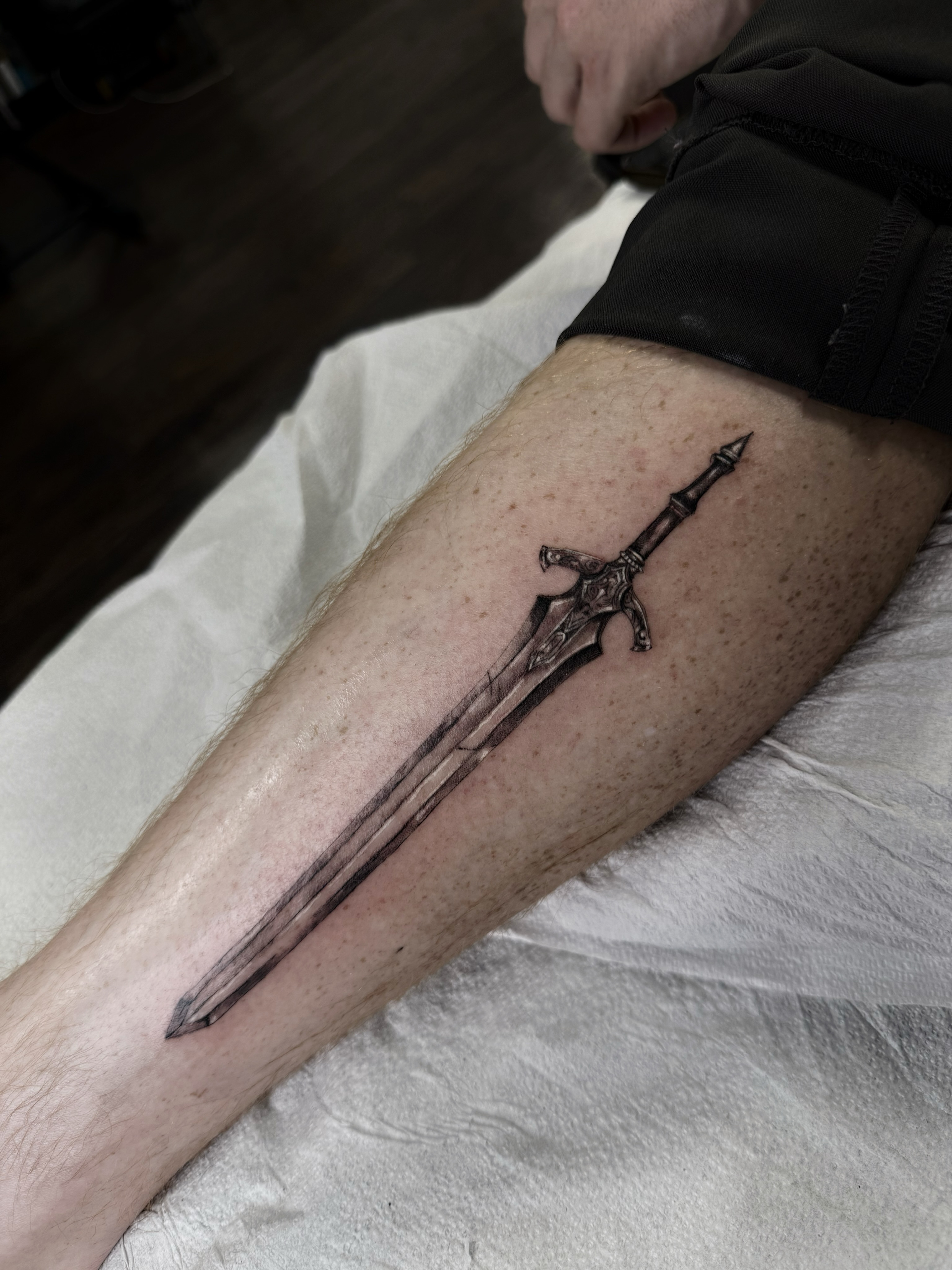 Sword black and grey tattoo on the forearm by viktoria raquel