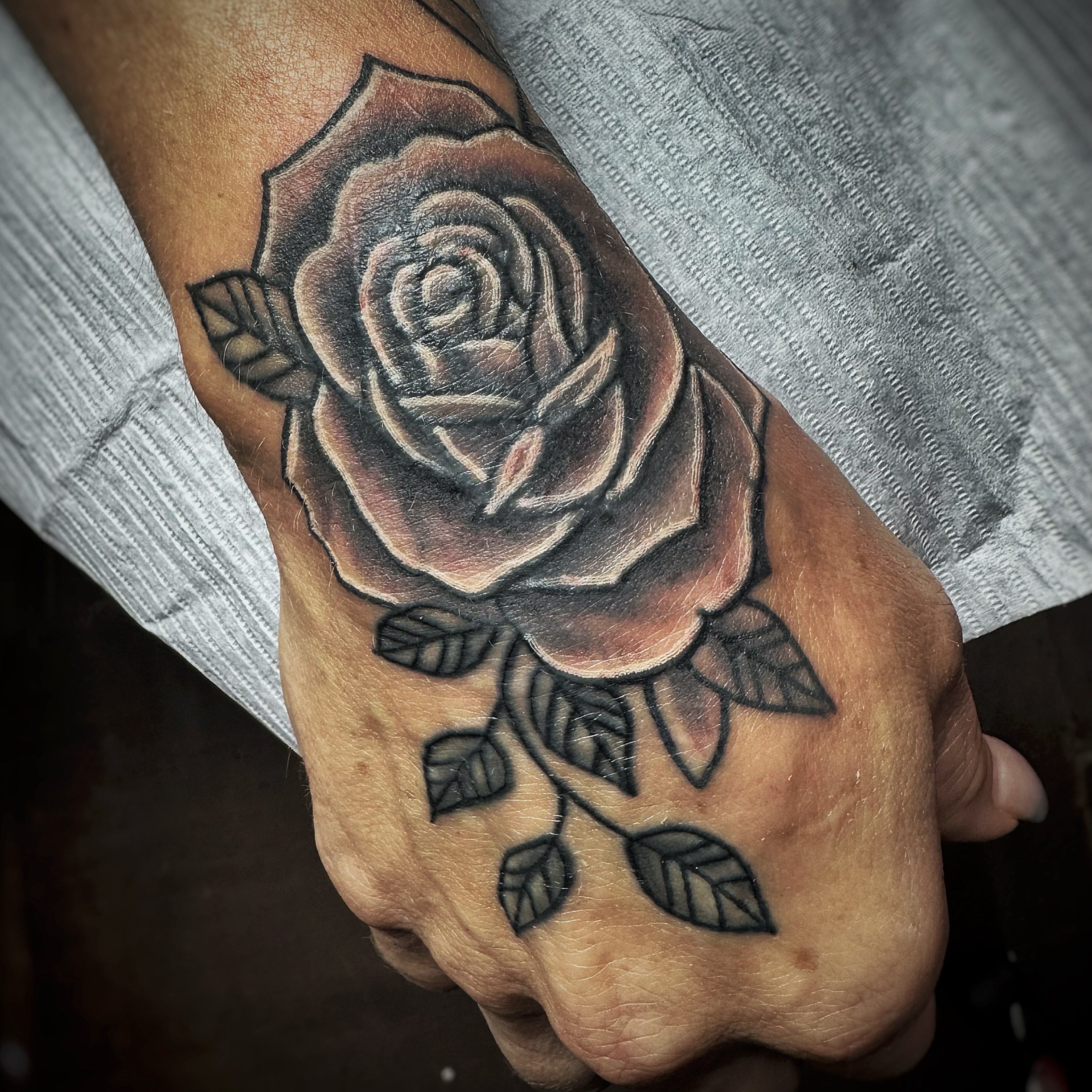 Rose black and grey tattoo on the hand by Anthony Guido