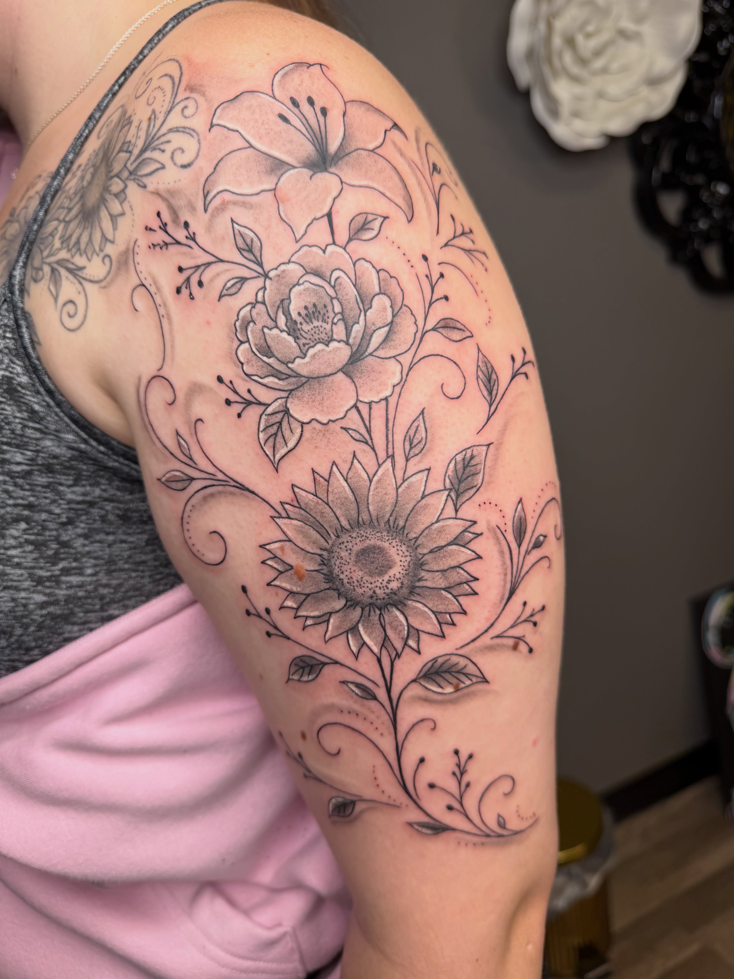 Floral arrangement ornamental tattoo on the shoulder by Rain David