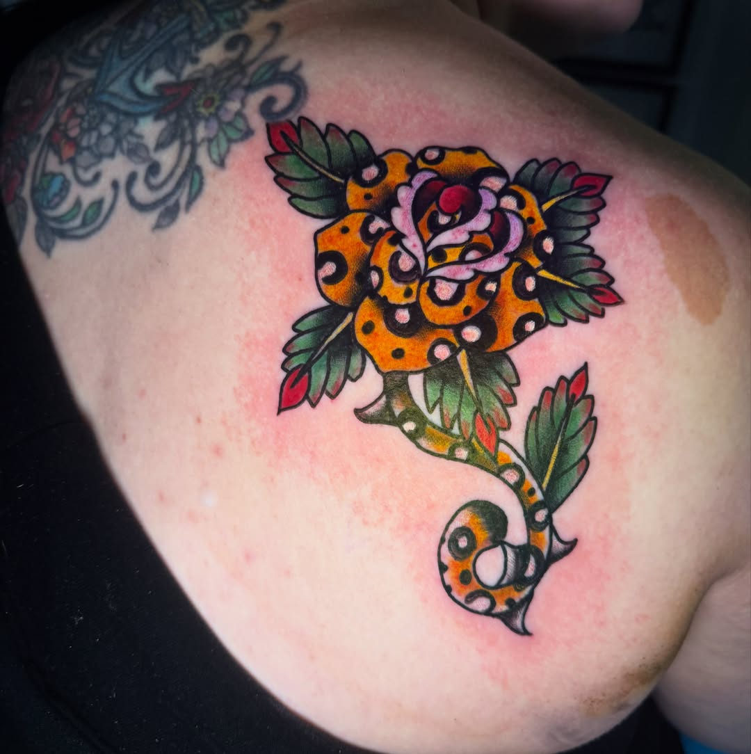 Leopard print rose American traditional tattoo on the shoulder by Arron Albaugh