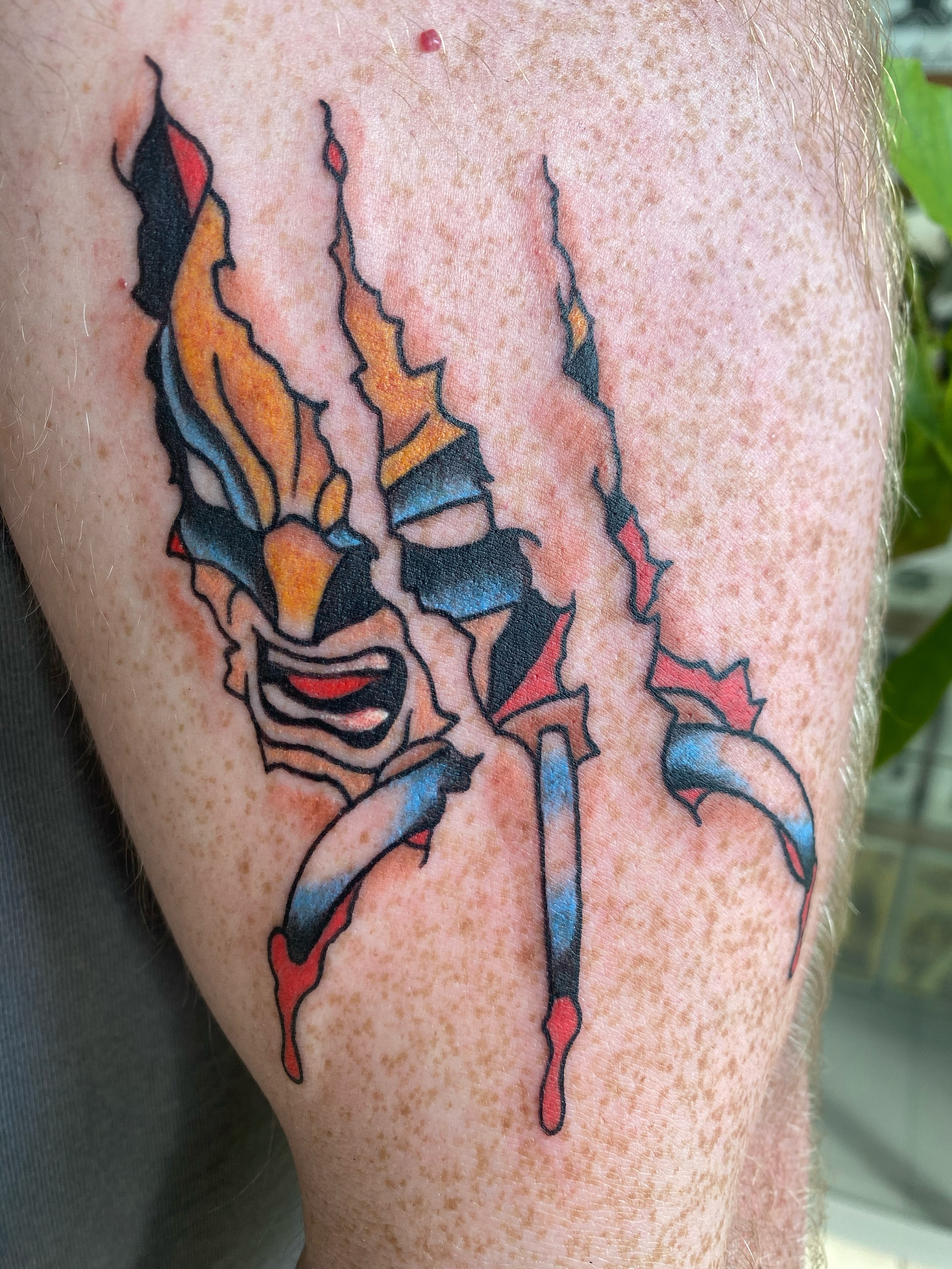 Mask neo-traditional tattoo on the thigh by Corinne Carter