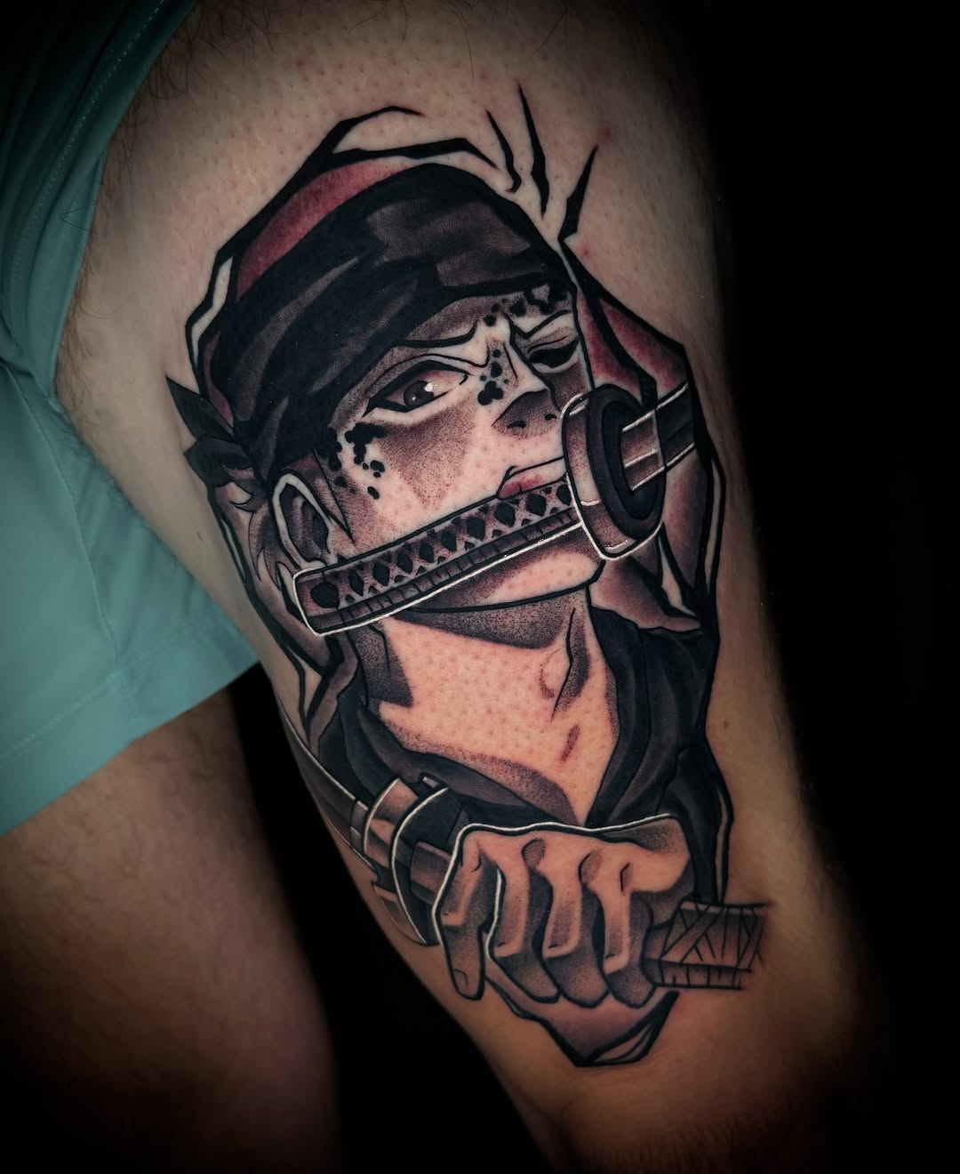 Harmonica player realism tattoo on the upper arm by Savannah Duff