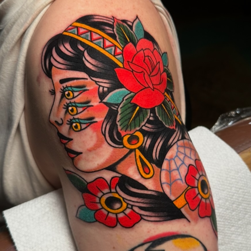 Woman with flowers American traditional tattoo on the forearm by Schyler Ames, Canal Fulton, Ohio