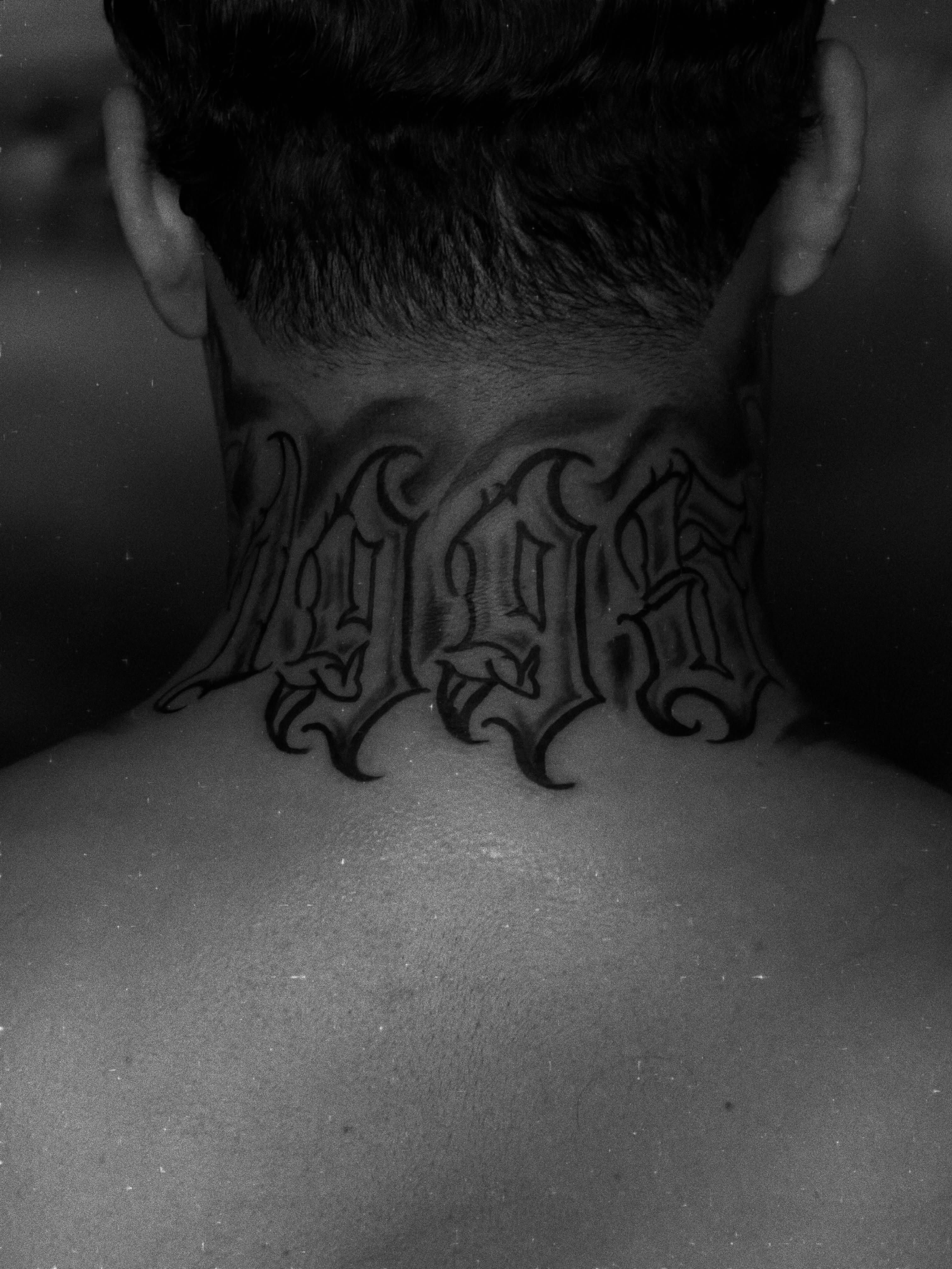 Gothic script lettering script tattoo on the neck by Messias Tattoo Artist