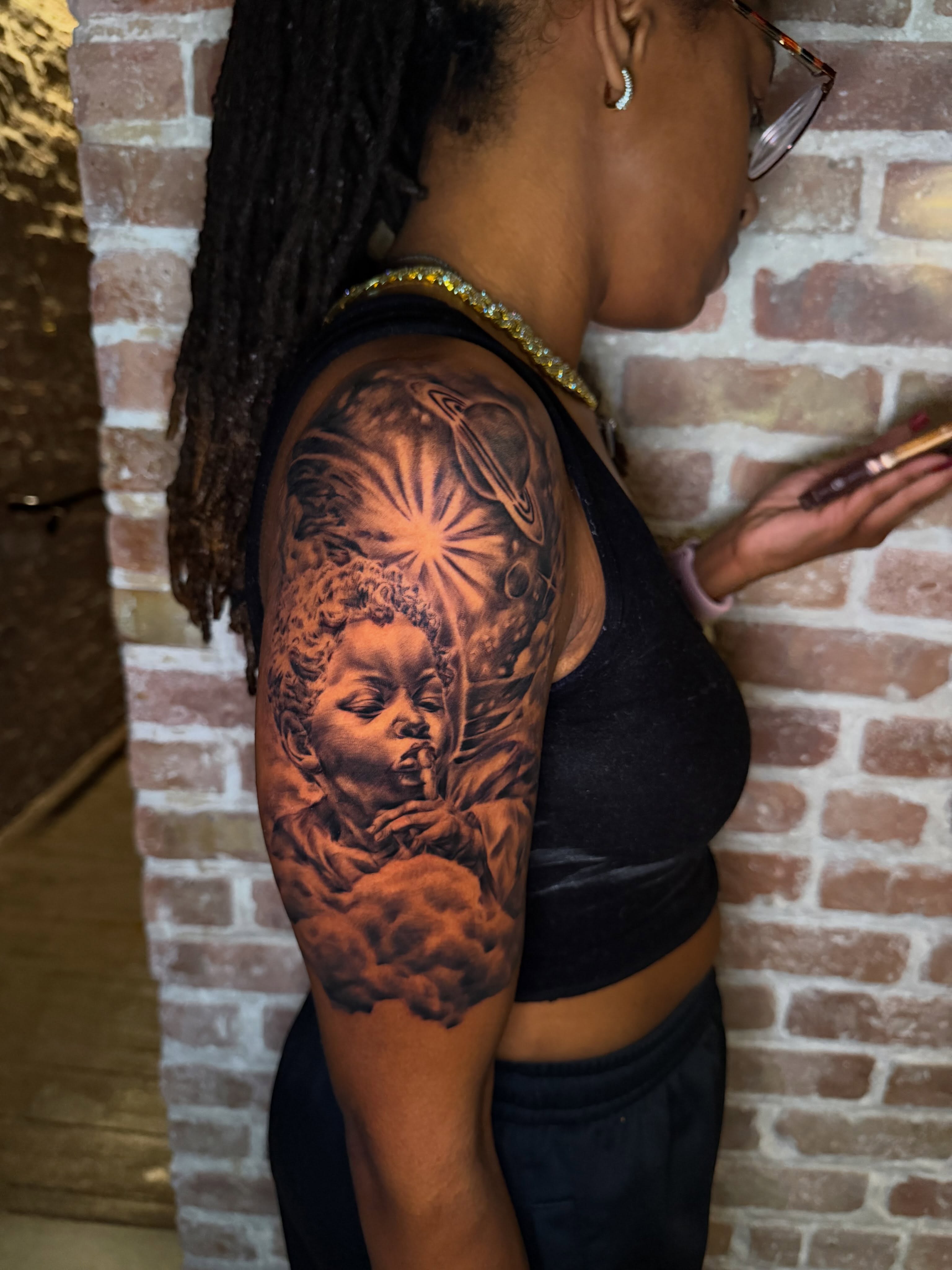 Child angel realism tattoo on the shoulder by Chicago Tattoo Artist