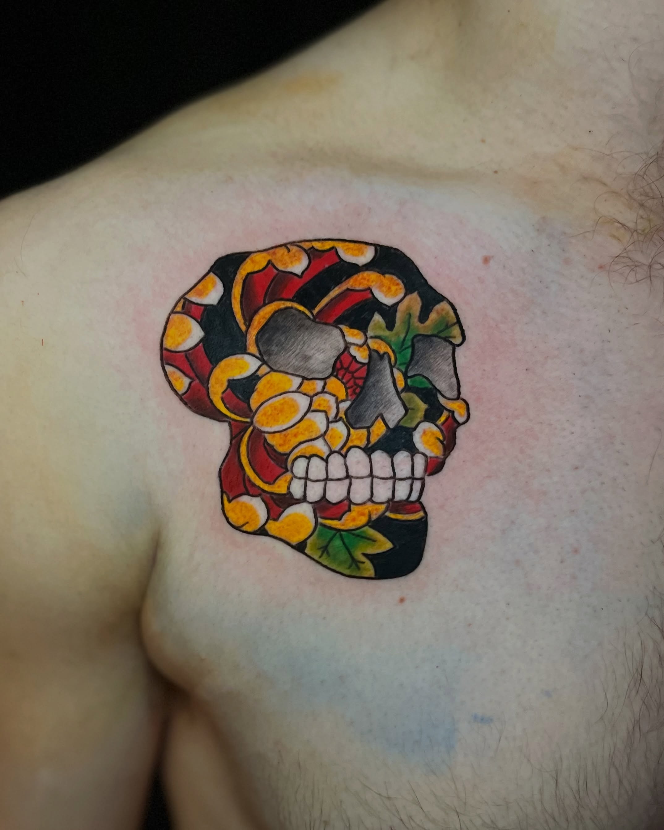 Skull American traditional tattoo on the chest by EO, Chicago, Illinois