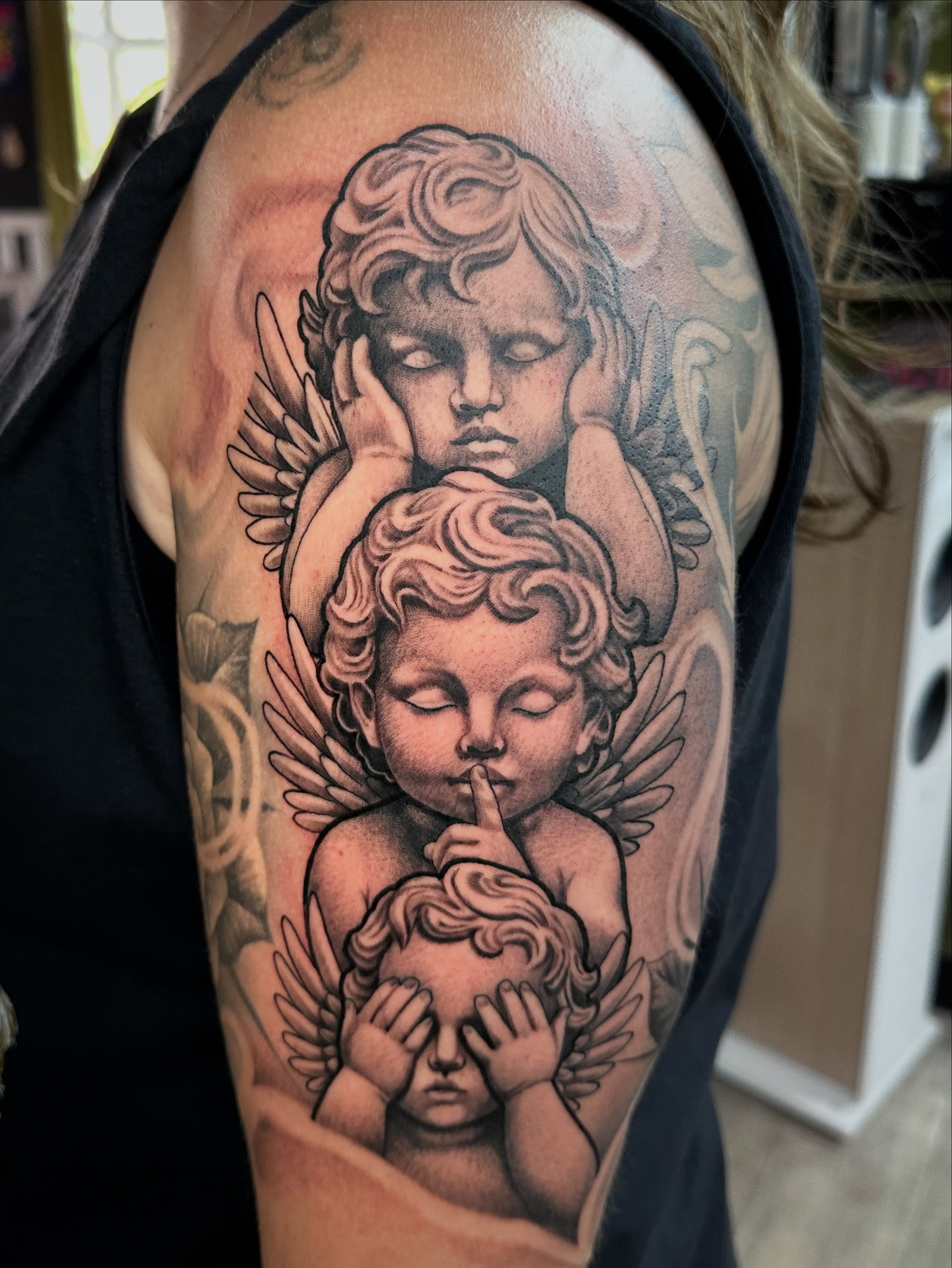 Cherubs realism tattoo on the upper arm by Dustin Clark, Dayton, Ohio