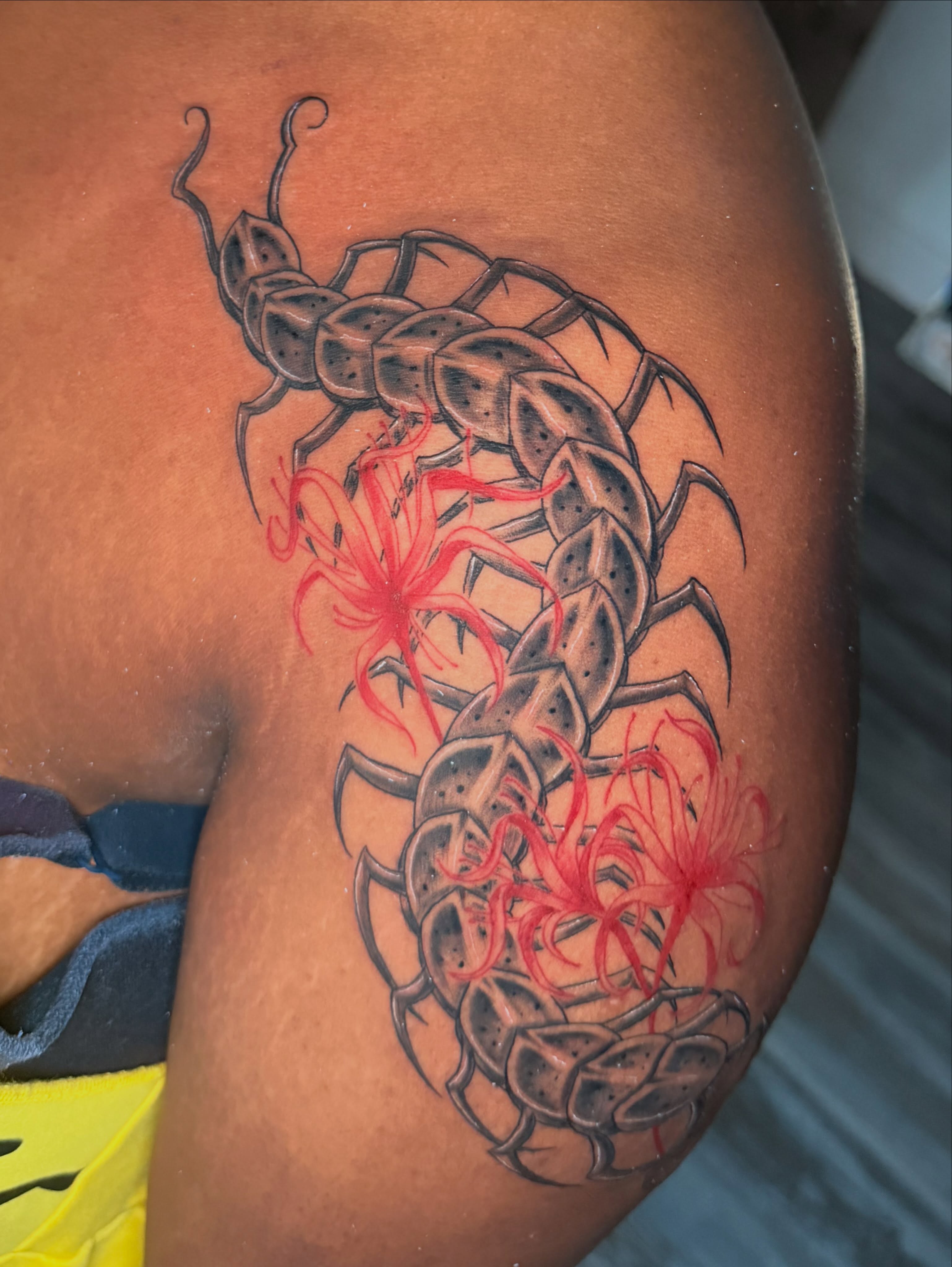 Centipede and flowers realism tattoo on the thigh by Breanna💉🔮, Dover, Delaware