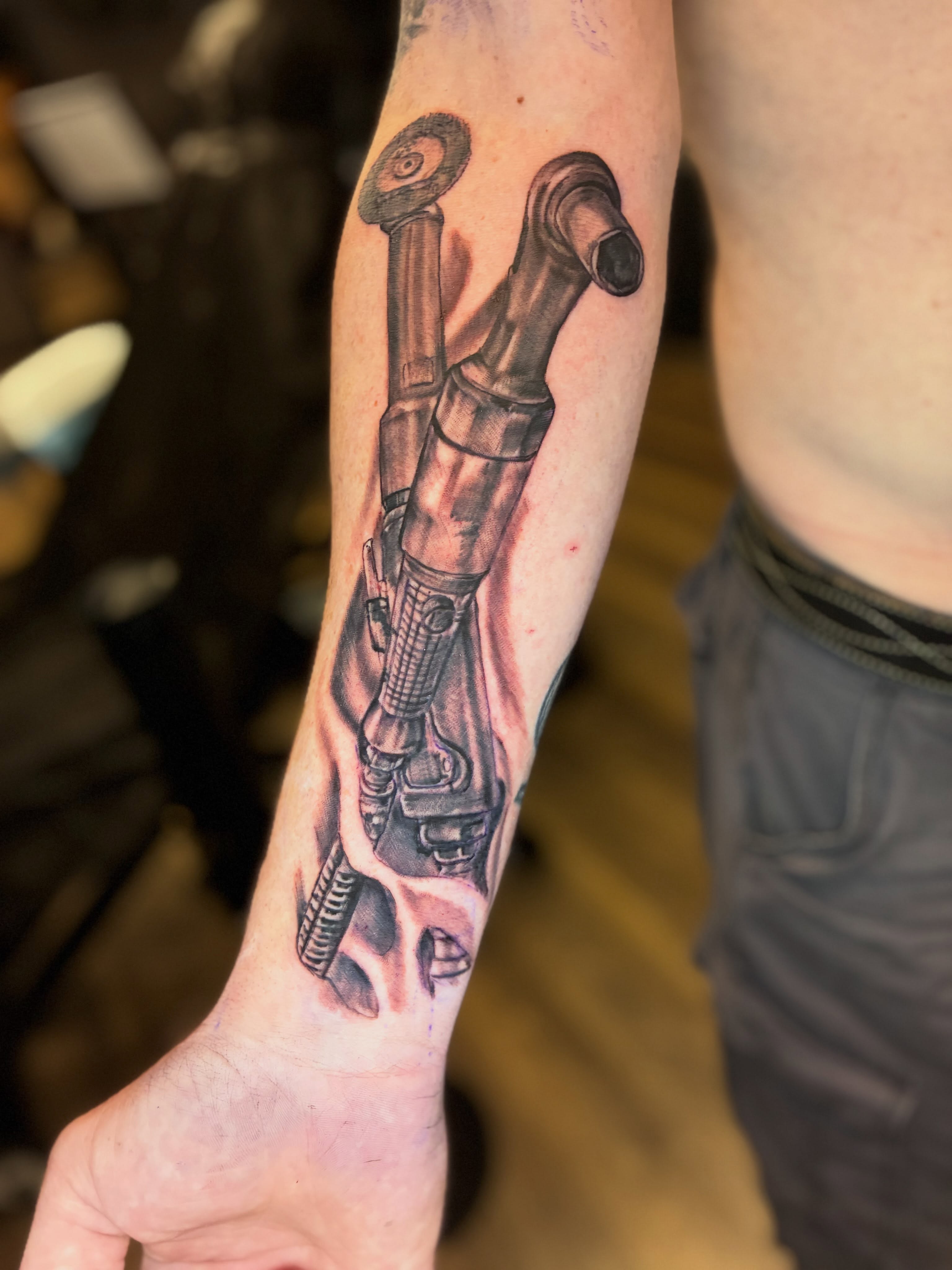Mechanical hand realism tattoo on the forearm by Kevin Strong