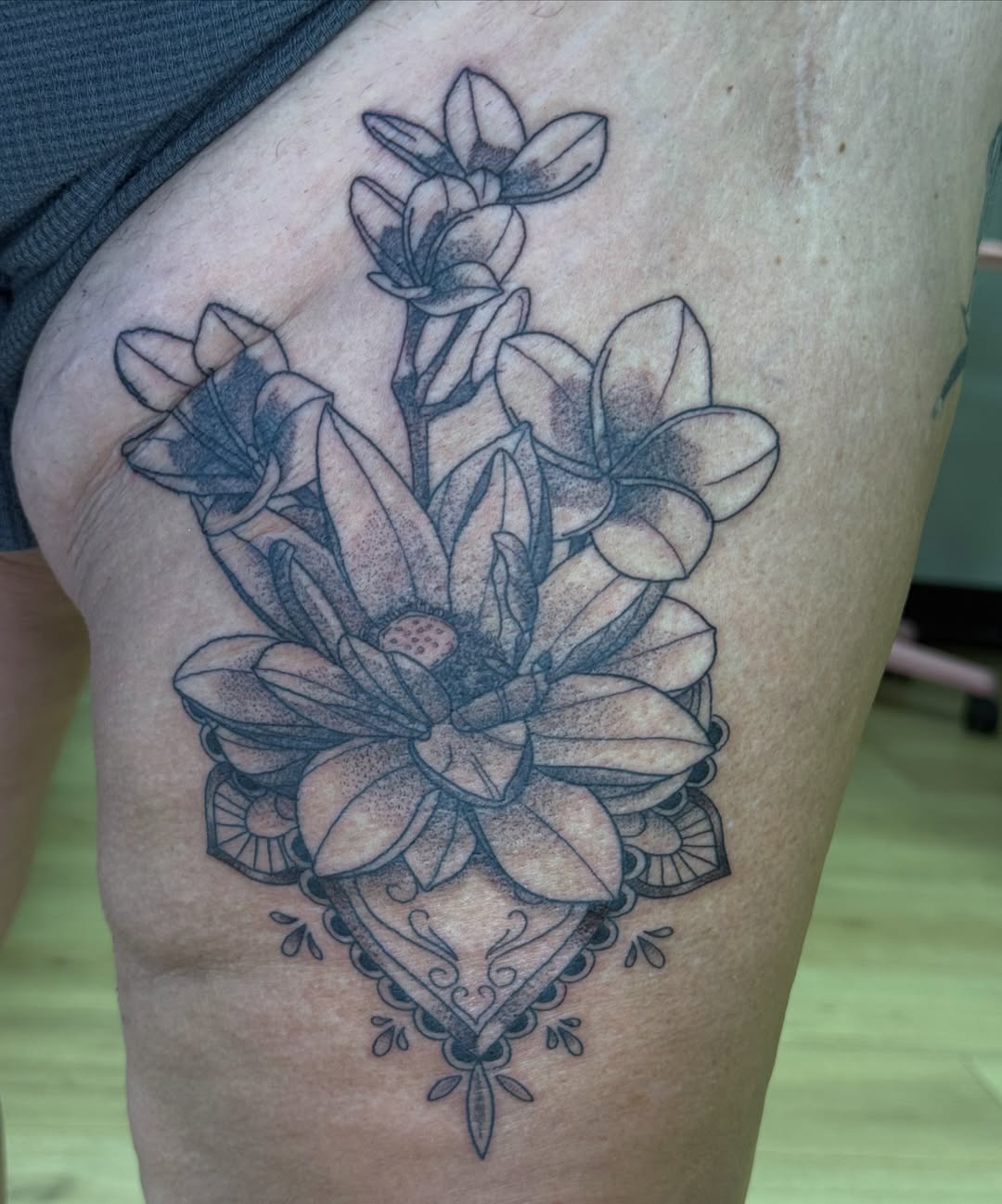 Flower bouquet dotwork tattoo on the thigh by Stvn Geyer, Urbandale, Iowa