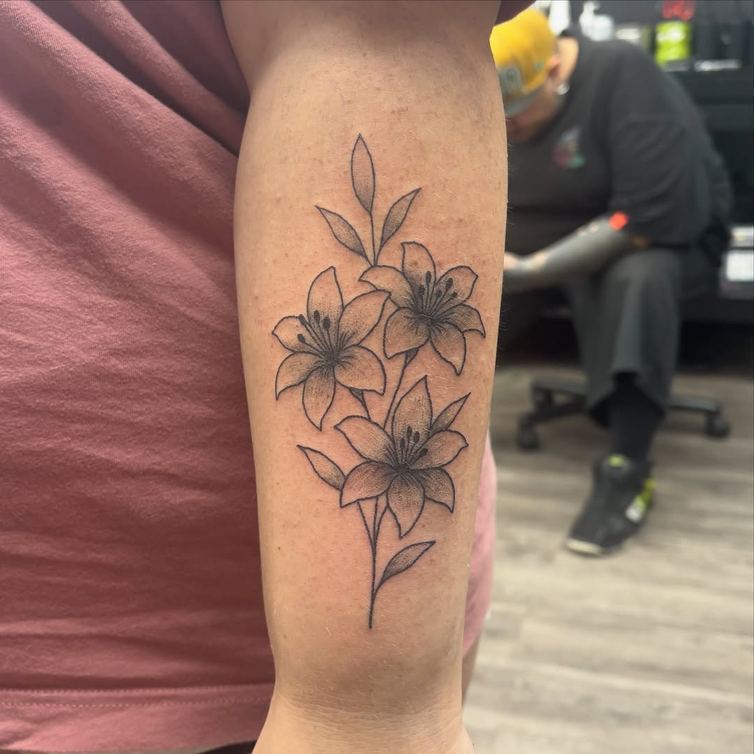 Lilies black and grey tattoo on the forearm by Joe ⋆₊⋆☢︎⁺₊⚠︎₊⋆