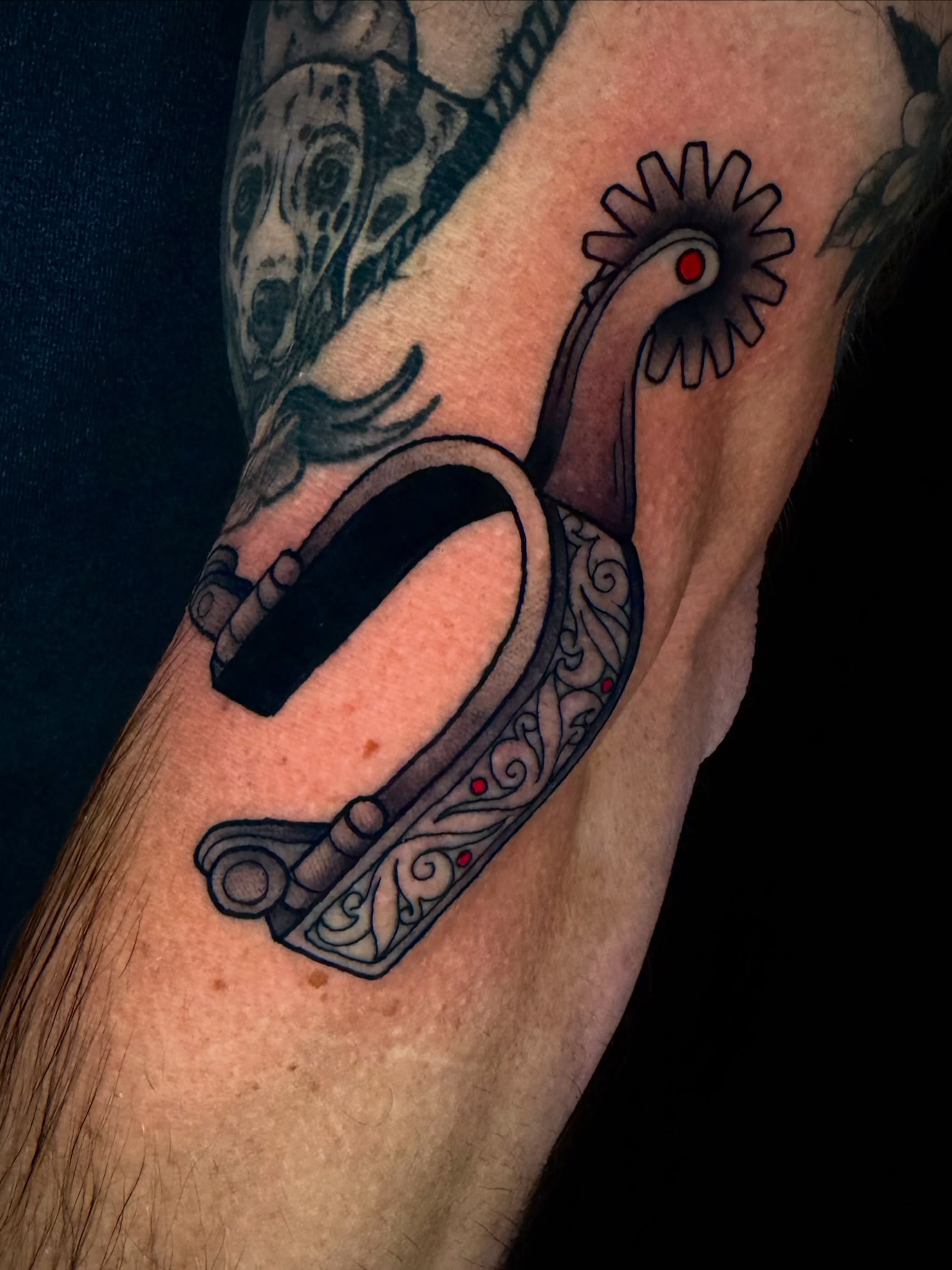 Spur American traditional tattoo on the forearm by Trenton Helms