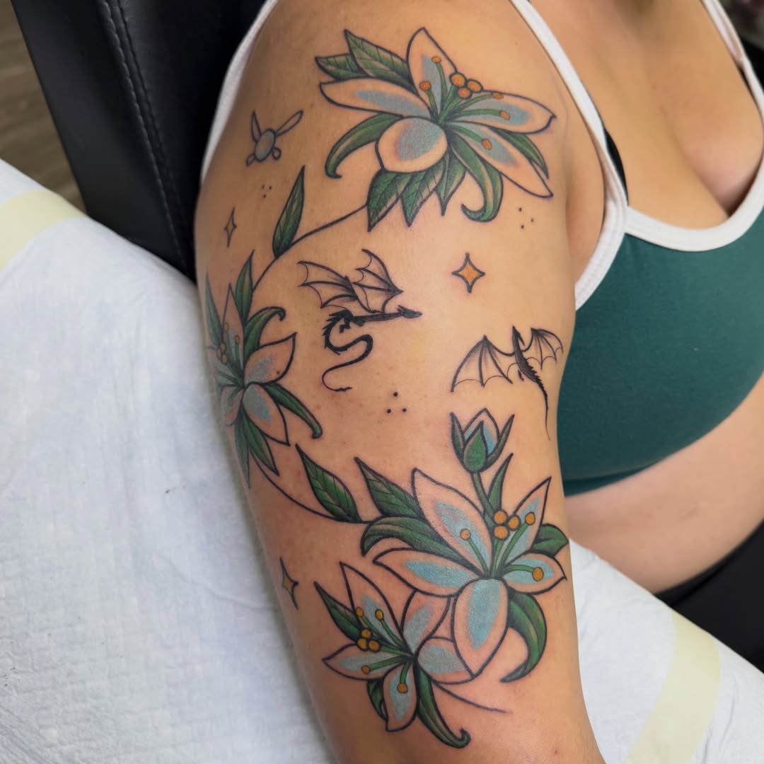 Flowers and dragons American traditional tattoo on the shoulder by Amy Kolton