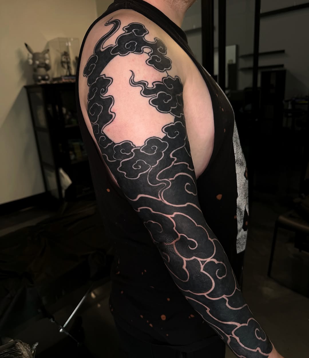 Clouds black and grey tattoo on the upper arm by Melissa "Lotuss" Chan
