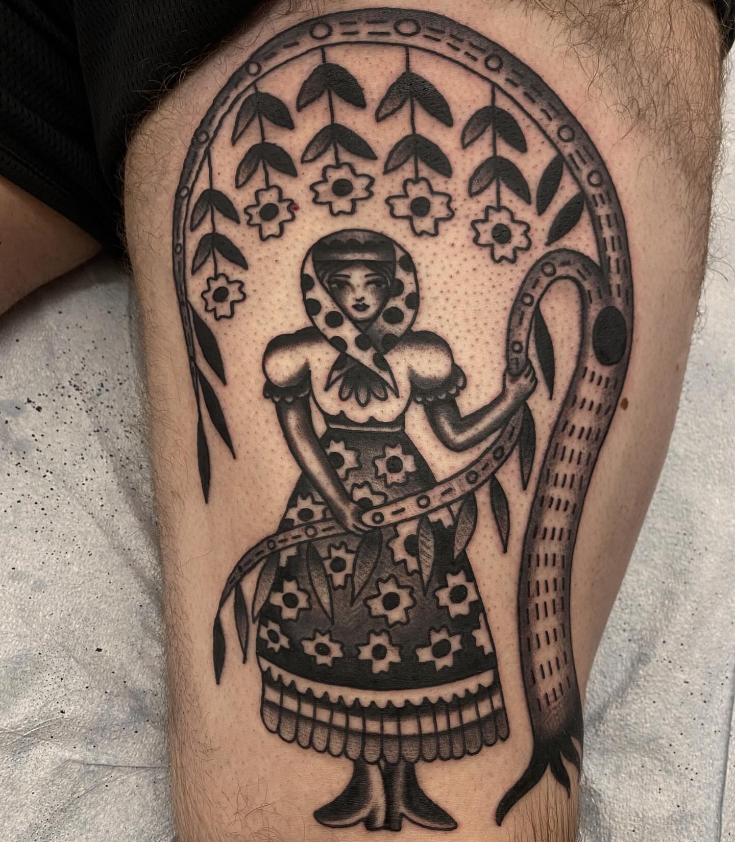 Woman with floral dress black and grey tattoo on the thigh by Abby Rose Estes