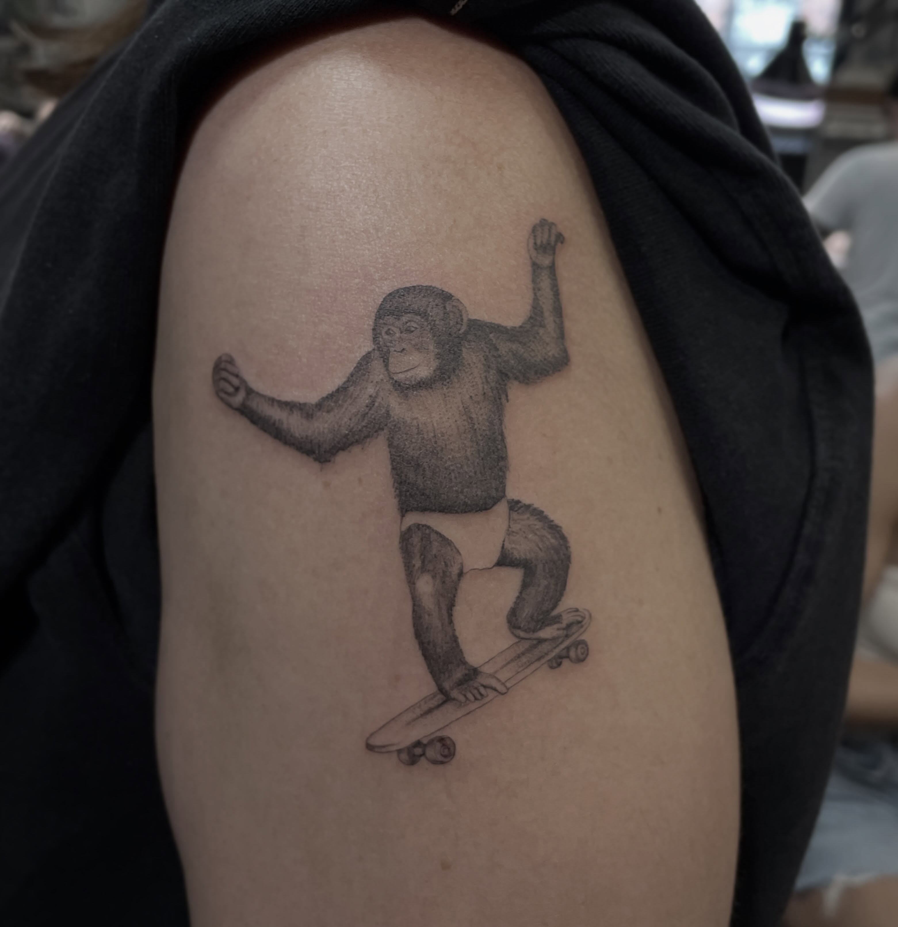 Monkey on skateboard dotwork tattoo on the shoulder by Jesus A.