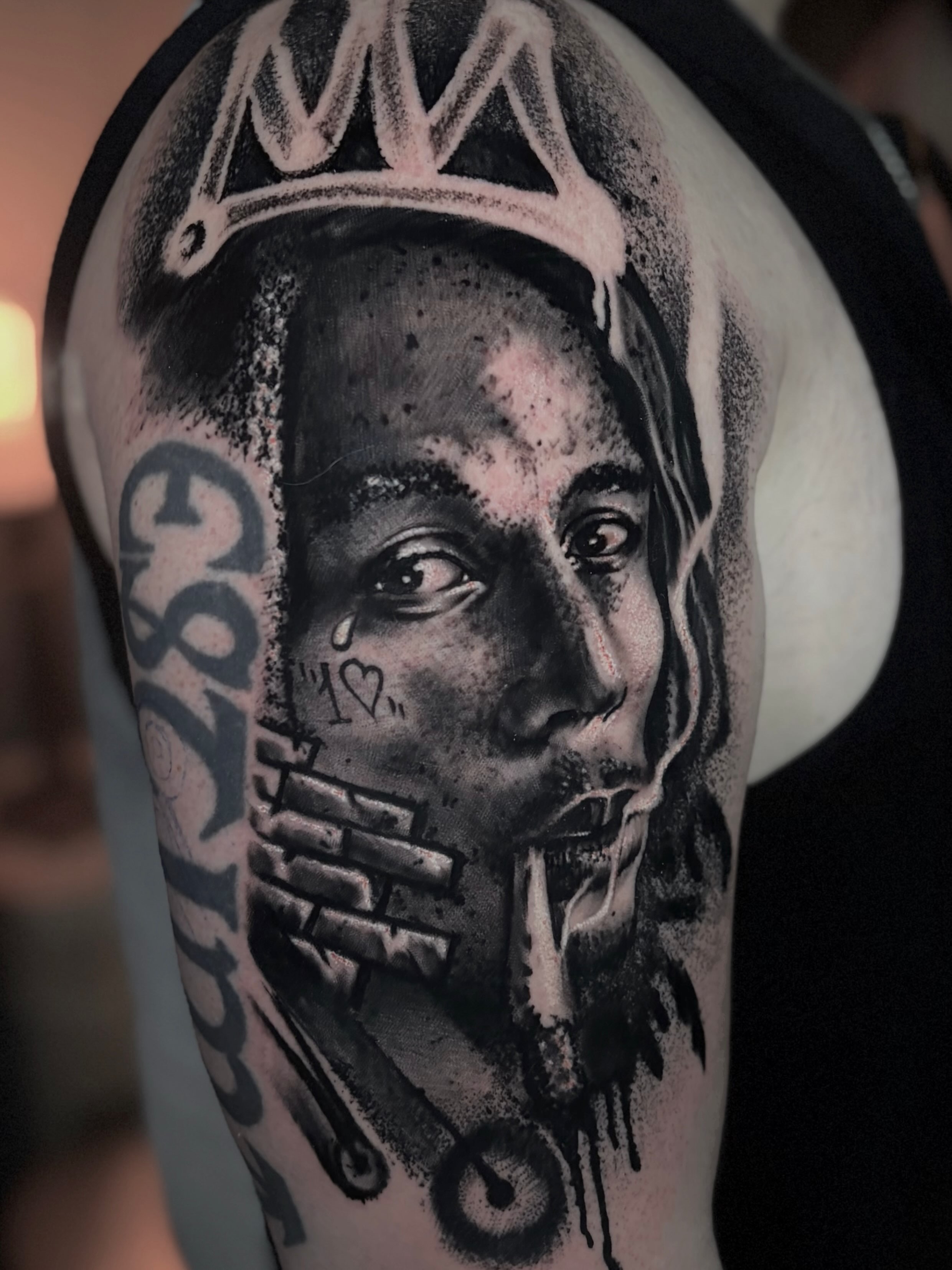 Portrait of a person realism tattoo on the shoulder by Italo Holie