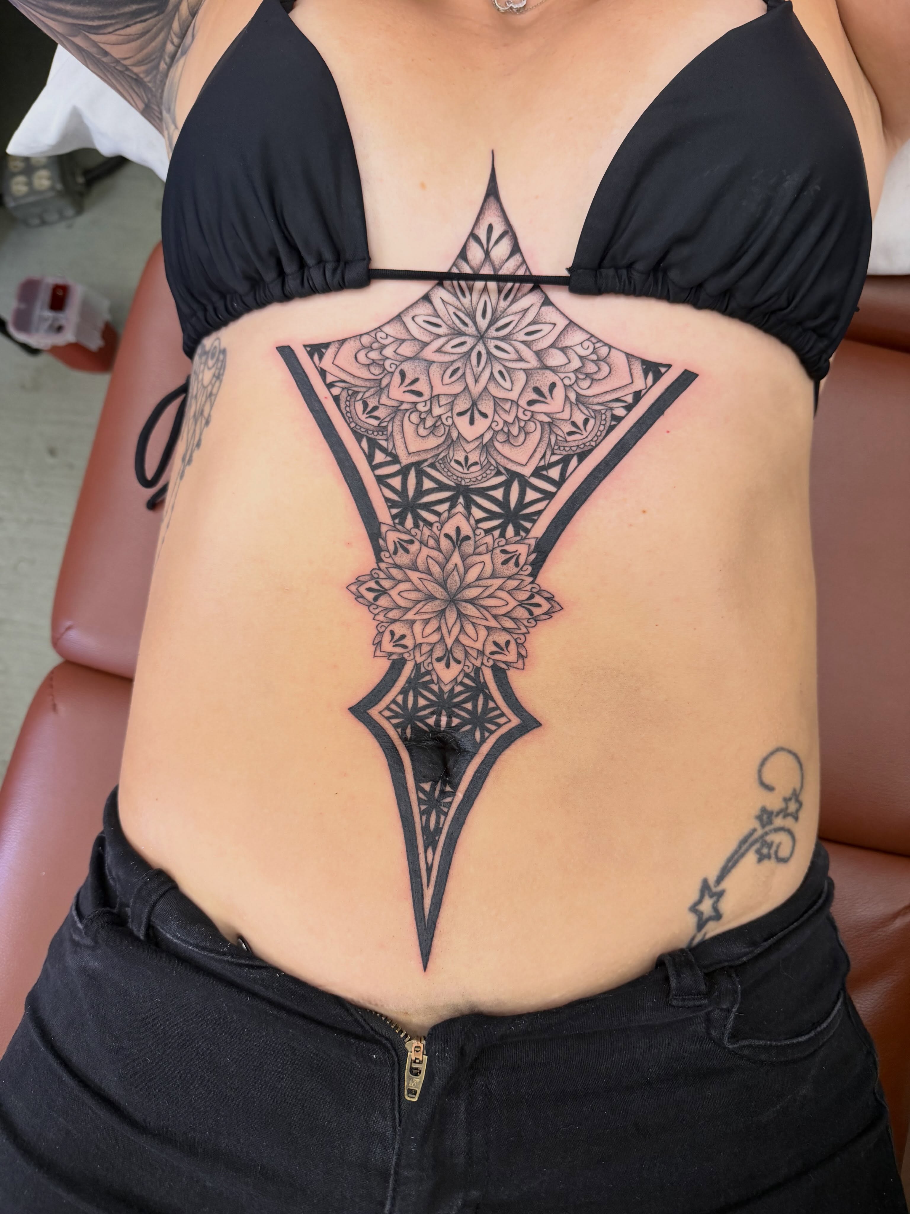 Mandala geometric tattoo on the torso by Hope Powell, Vancouver, Washington