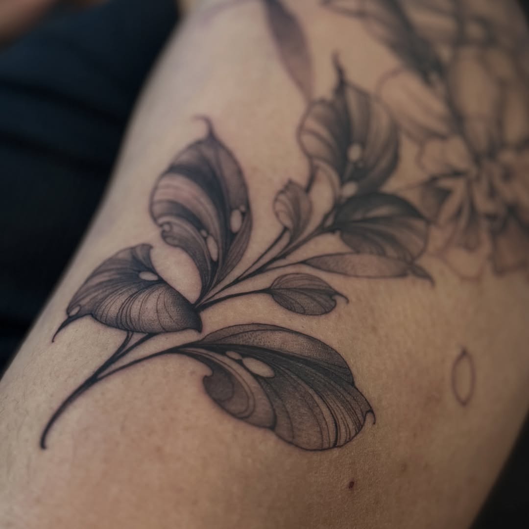Calla lilies black and grey tattoo on the upper arm by Sena Sim 🇰🇭, Worcester, Massachusetts