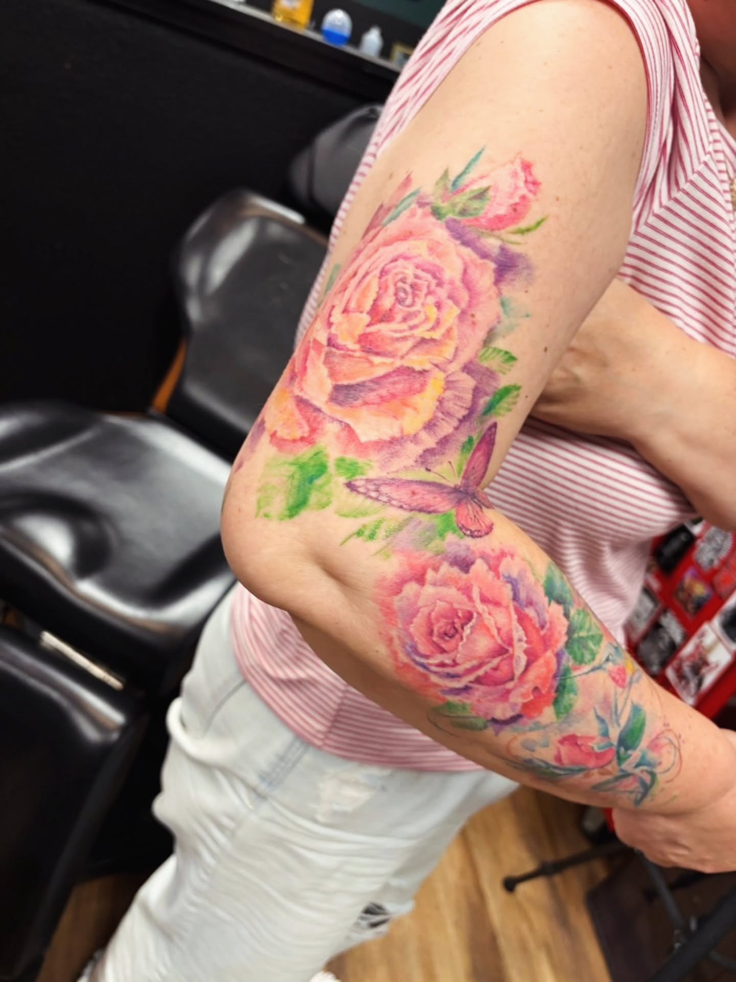 Watercolor roses and butterfly watercolor tattoo on the forearm by Dr. Valerio Vegas Tattoo