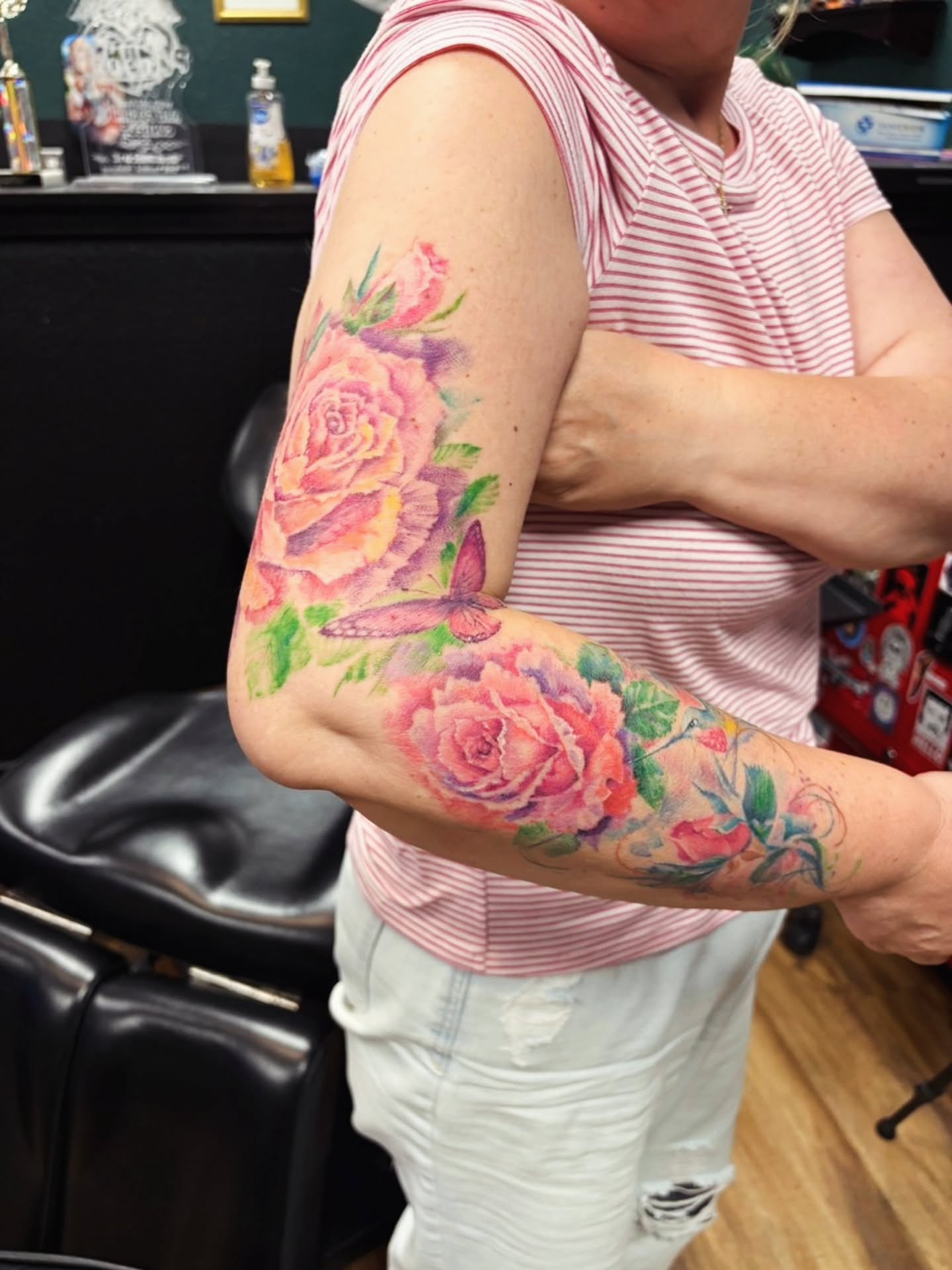 Roses and butterfly watercolor tattoo on the forearm by Dr. Valerio Vegas Tattoo