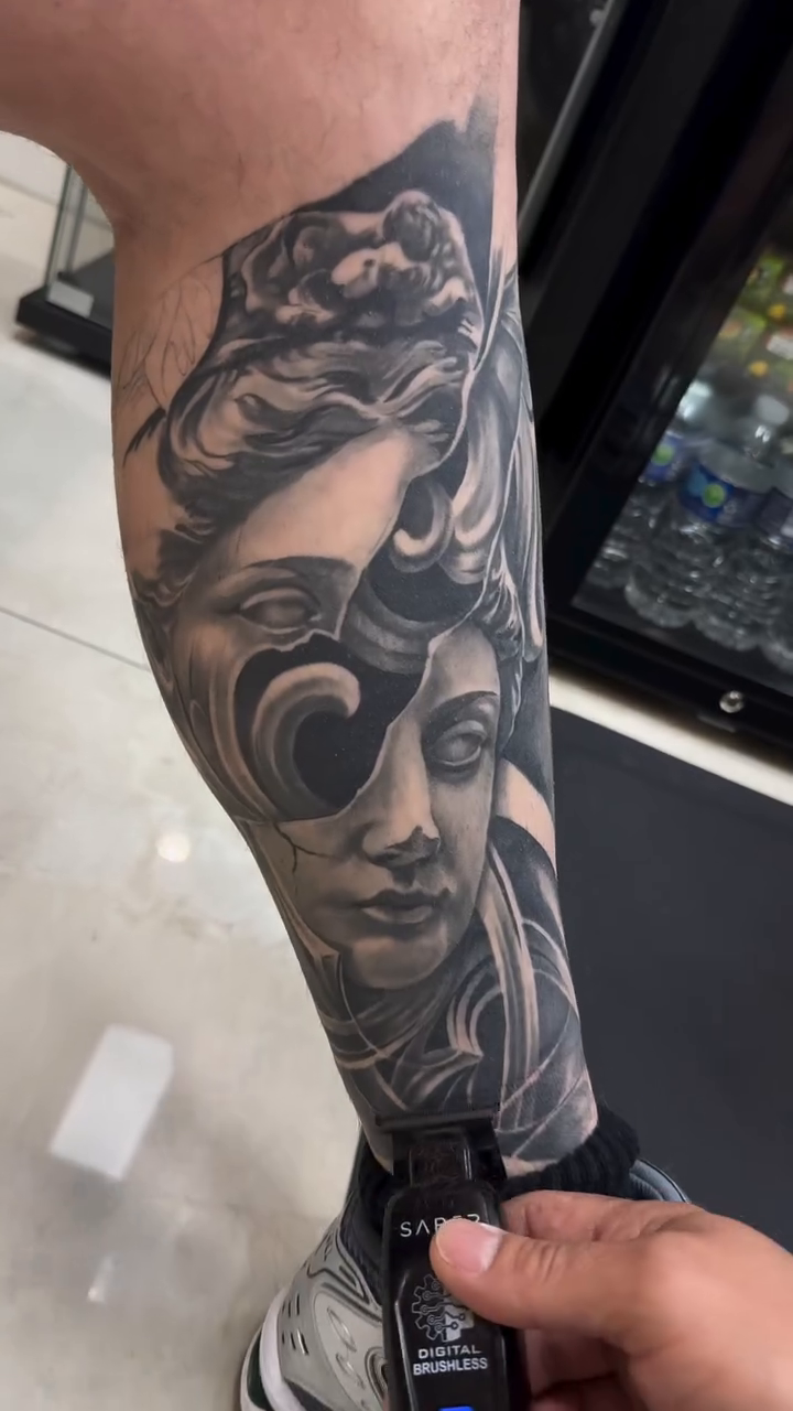 Grecian statue face with flowing drapery realism tattoo by Andres García Baeza