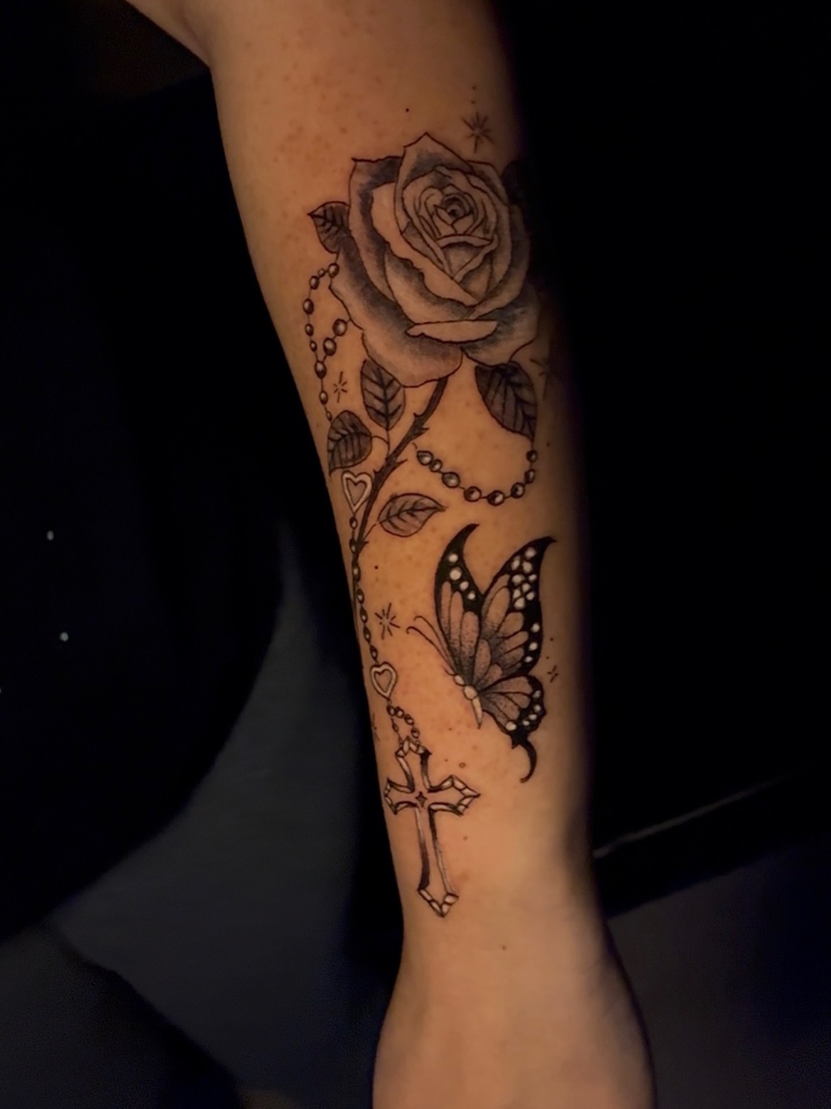 Rose and butterfly black and grey tattoo on the forearm by Tattzbyluma, Charlotte, North Carolina