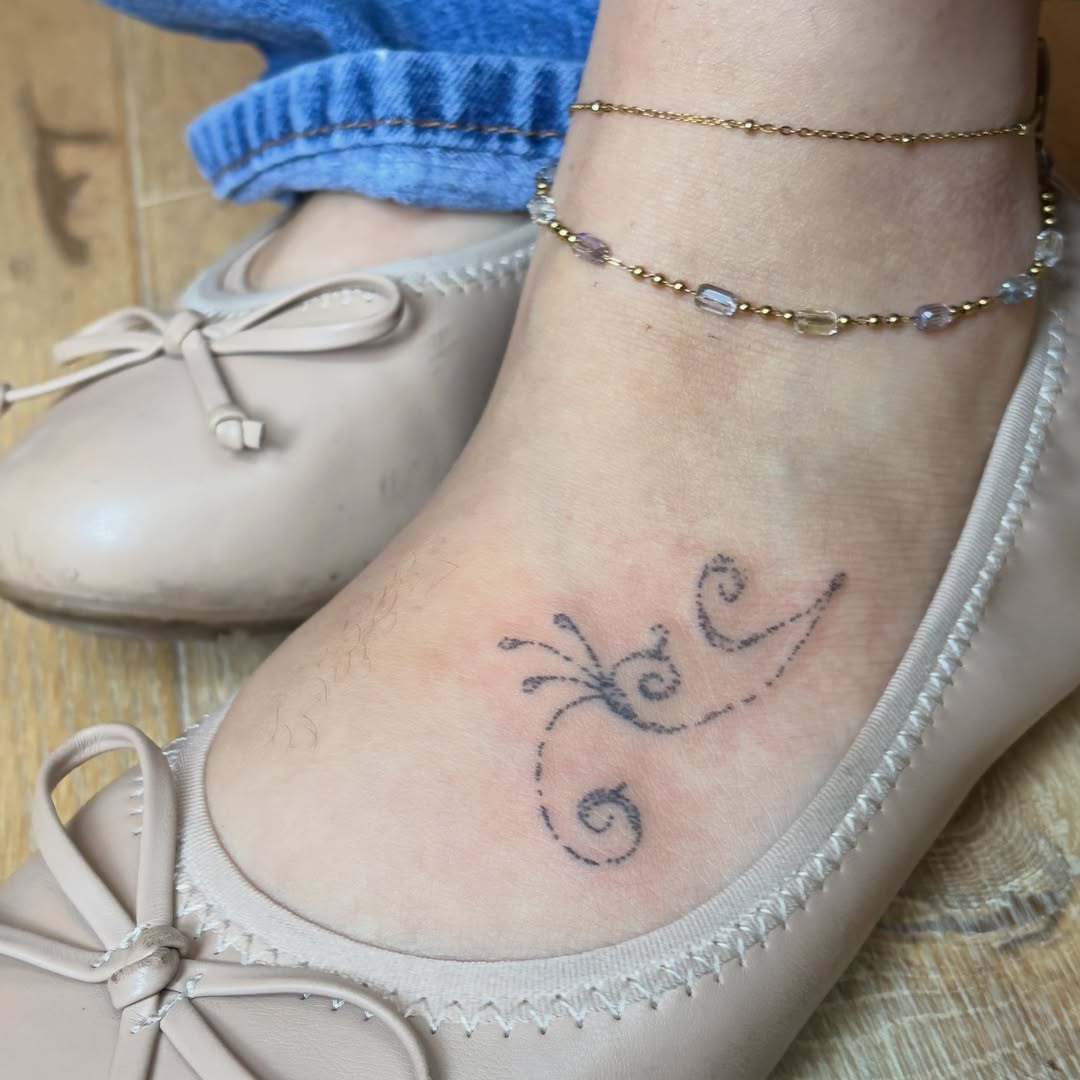 Butterfly fine line tattoo on the foot by kari