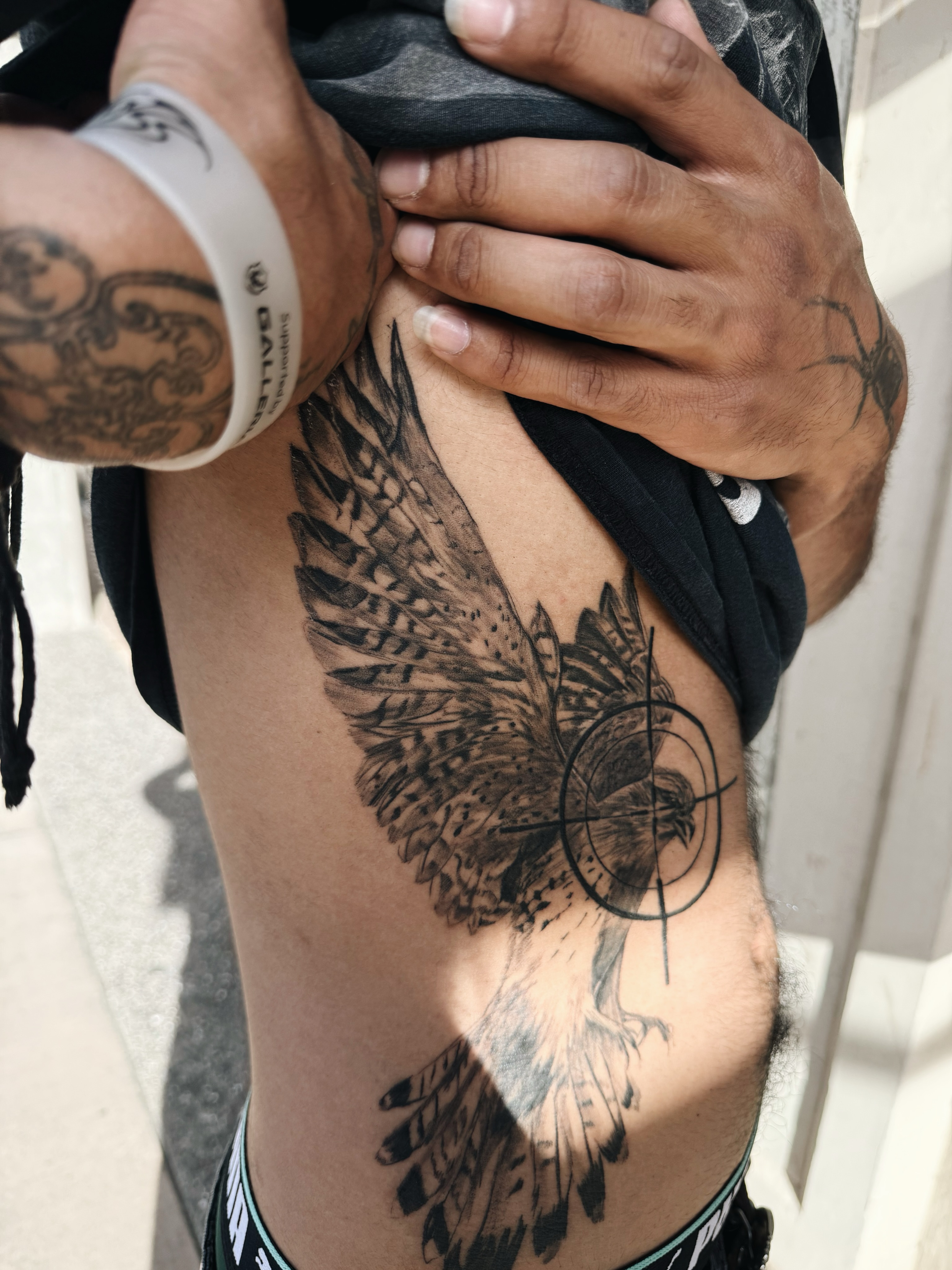 Hawk with target realism tattoo on the chest by viktoria raquel