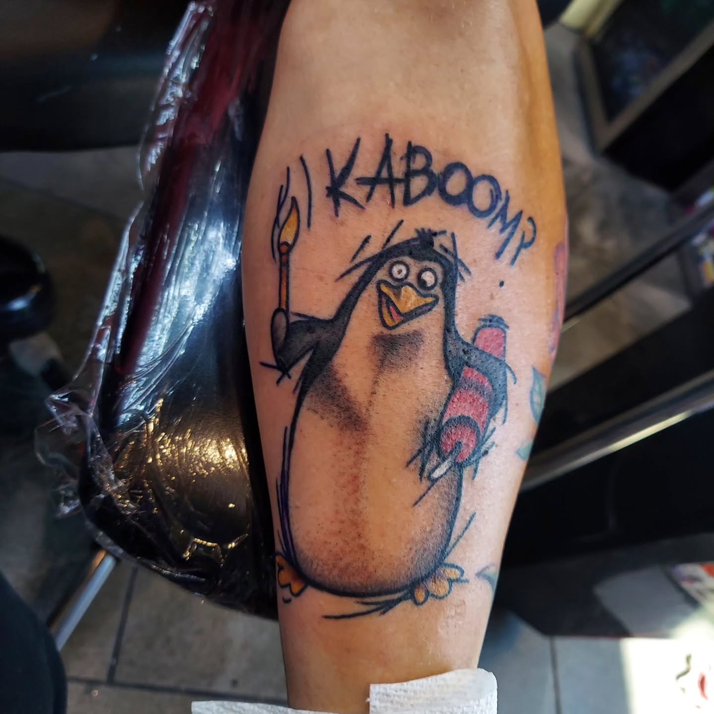 Penguin illustrative tattoo on the forearm by Kari Rhoades, Marion, Iowa