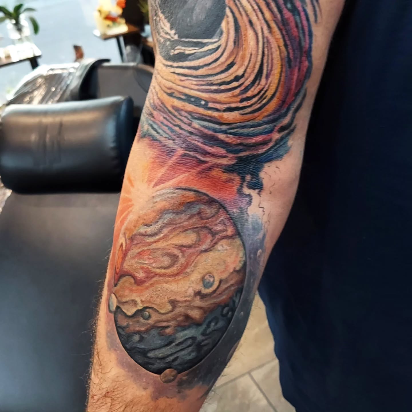 Planetary storm realism tattoo on the forearm by Kari Rhoades, Marion, Iowa