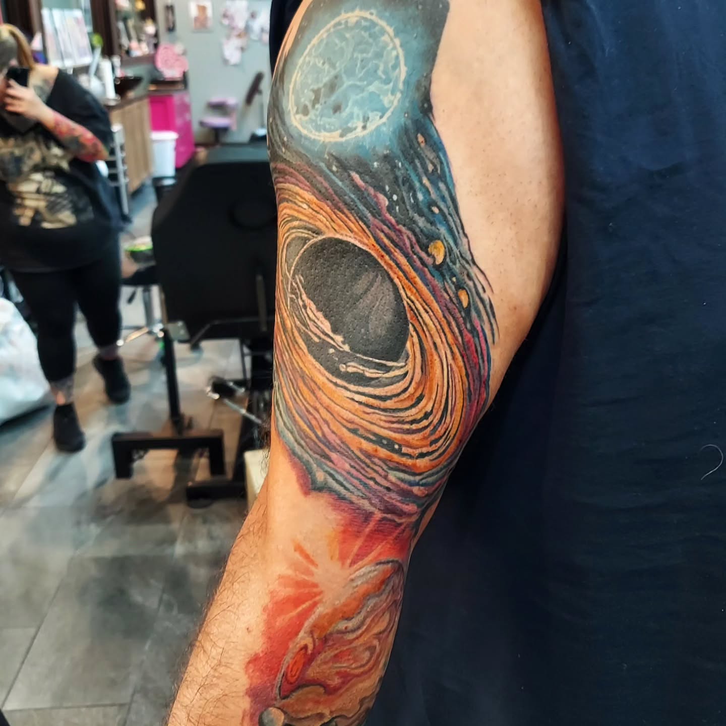 Cosmic vortex dotwork tattoo on the forearm by Kari Rhoades, Marion, Iowa