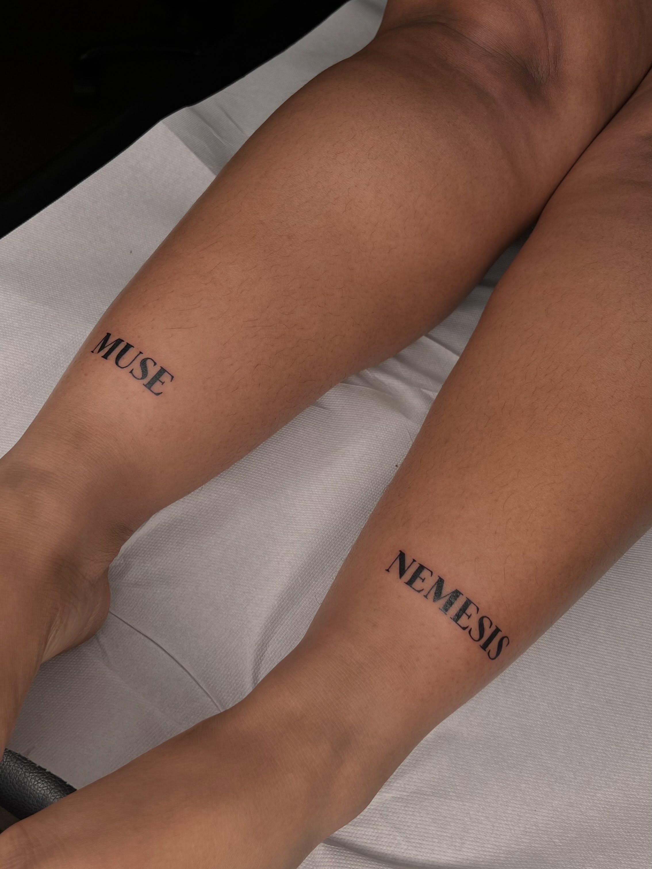 Muse and nemesis lettering script tattoo on the forearm by Tattoo (Réaliste), Toulouse, Occitanie