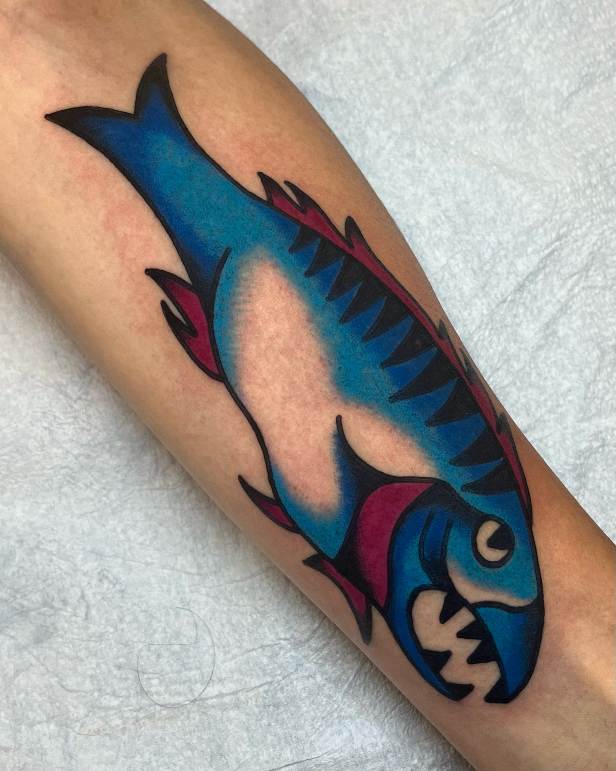 Fish American traditional tattoo on the forearm by Em Adkins