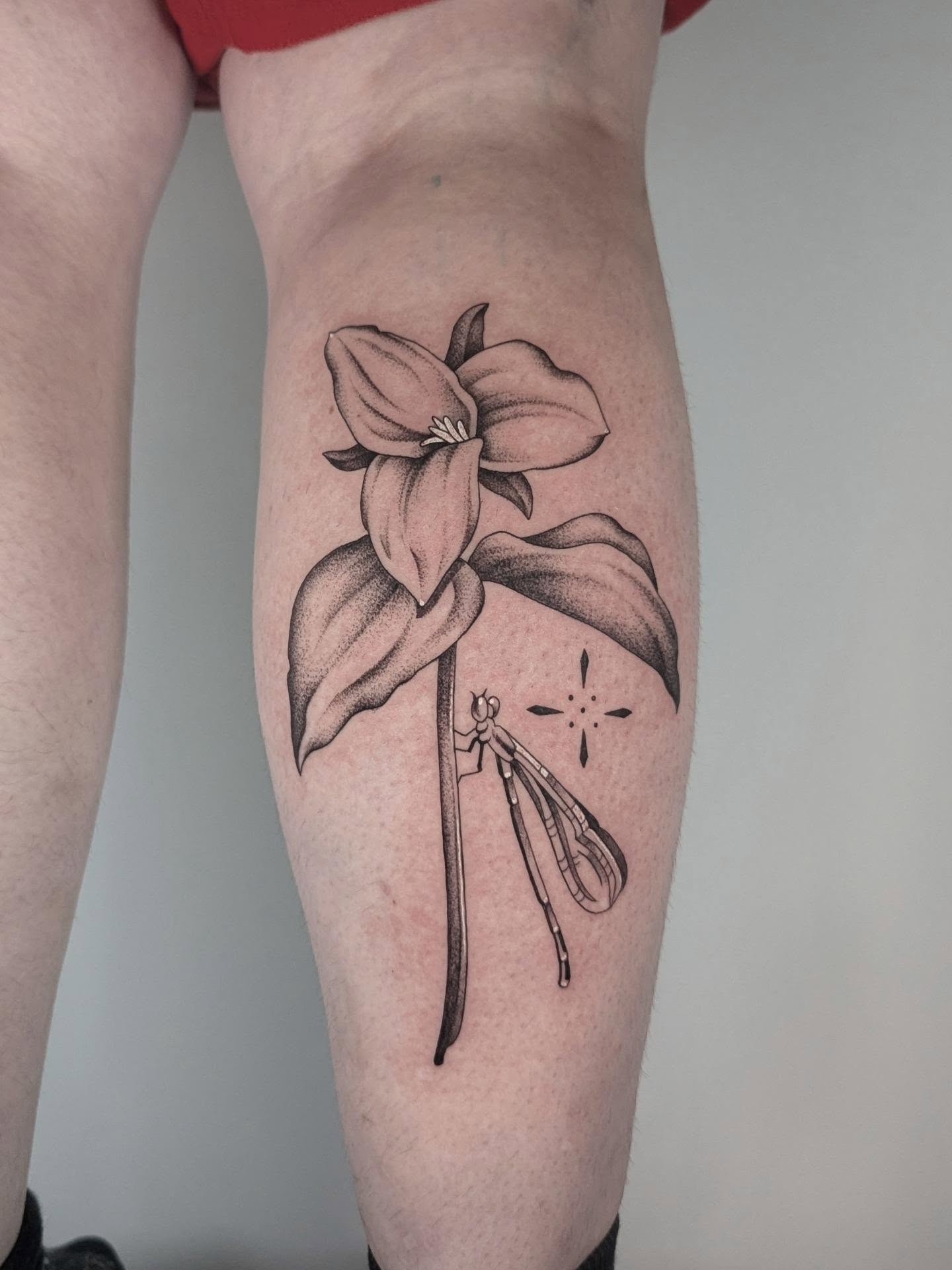 Flower and insect dotwork tattoo on the forearm by Courtney Yaddof
