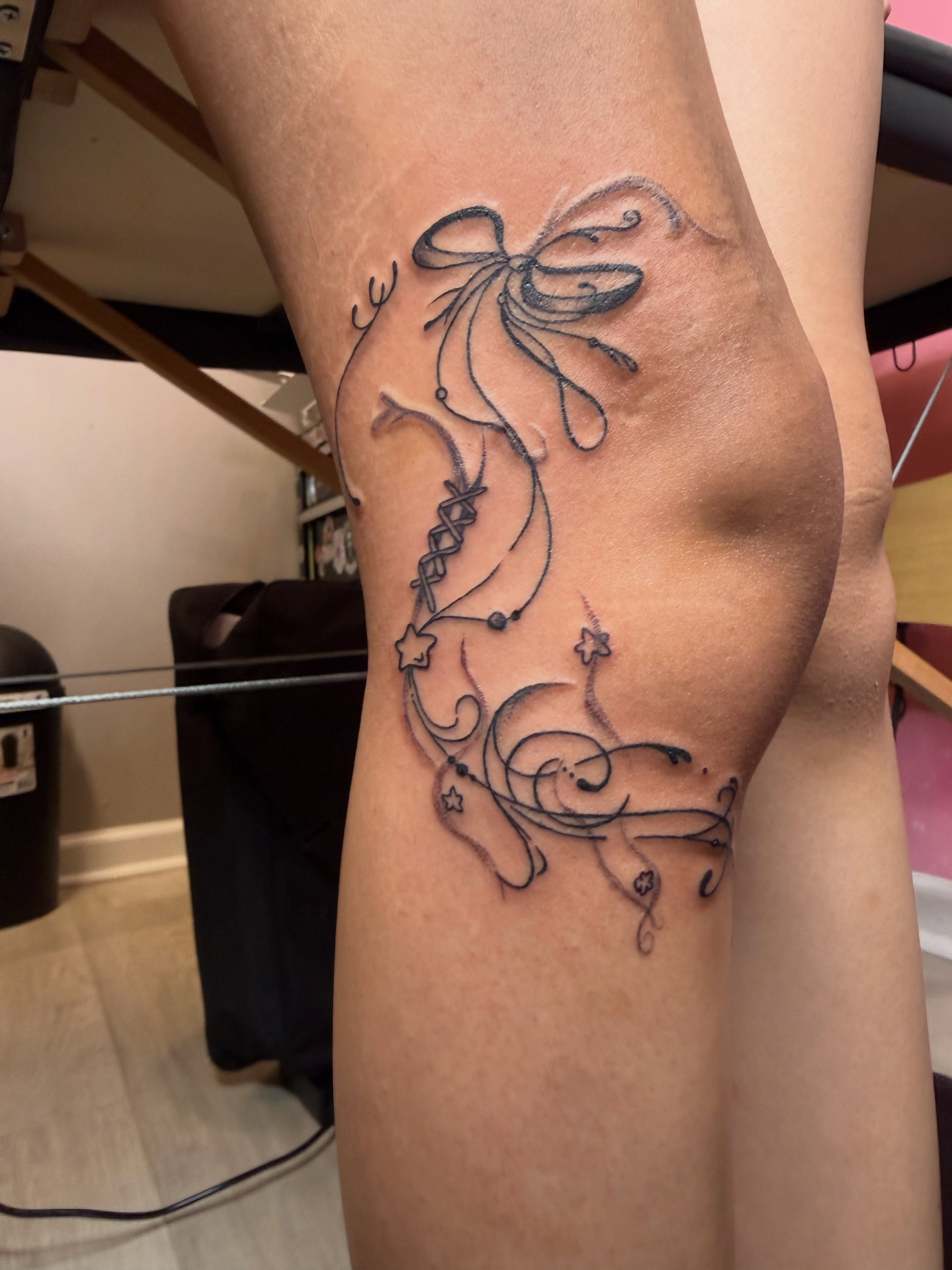 Bow and floral vine black and grey tattoo on the forearm by Room 707 Tattoo 🍰🍓