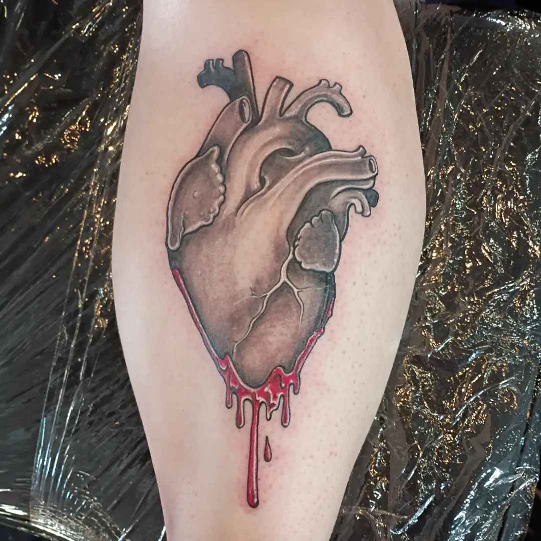 Bleeding heart realism tattoo on the thigh by Niki Jackson