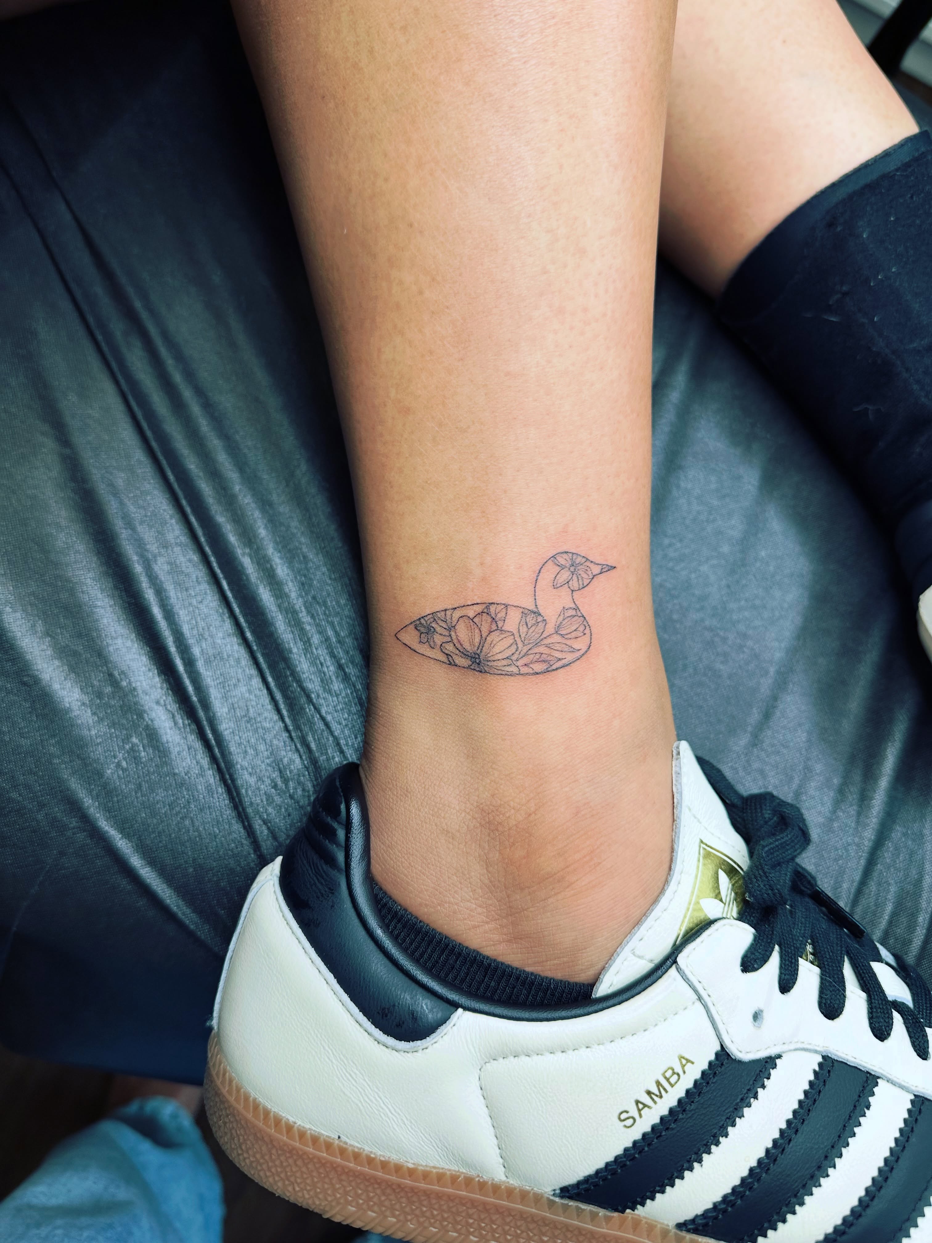 Swan fine line tattoo on the calf by Liz