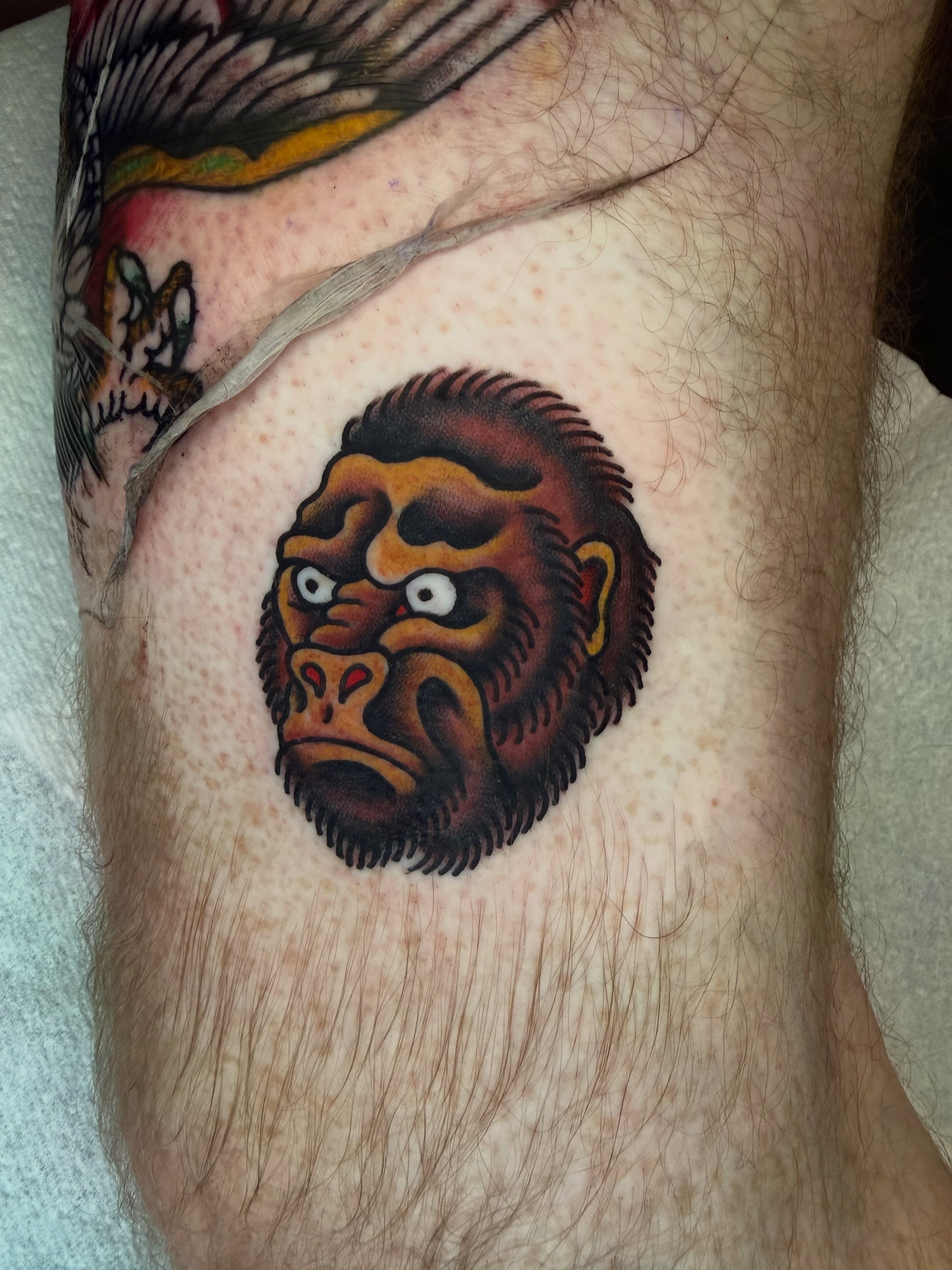 Gorilla head American traditional tattoo on the forearm by Atom Aker