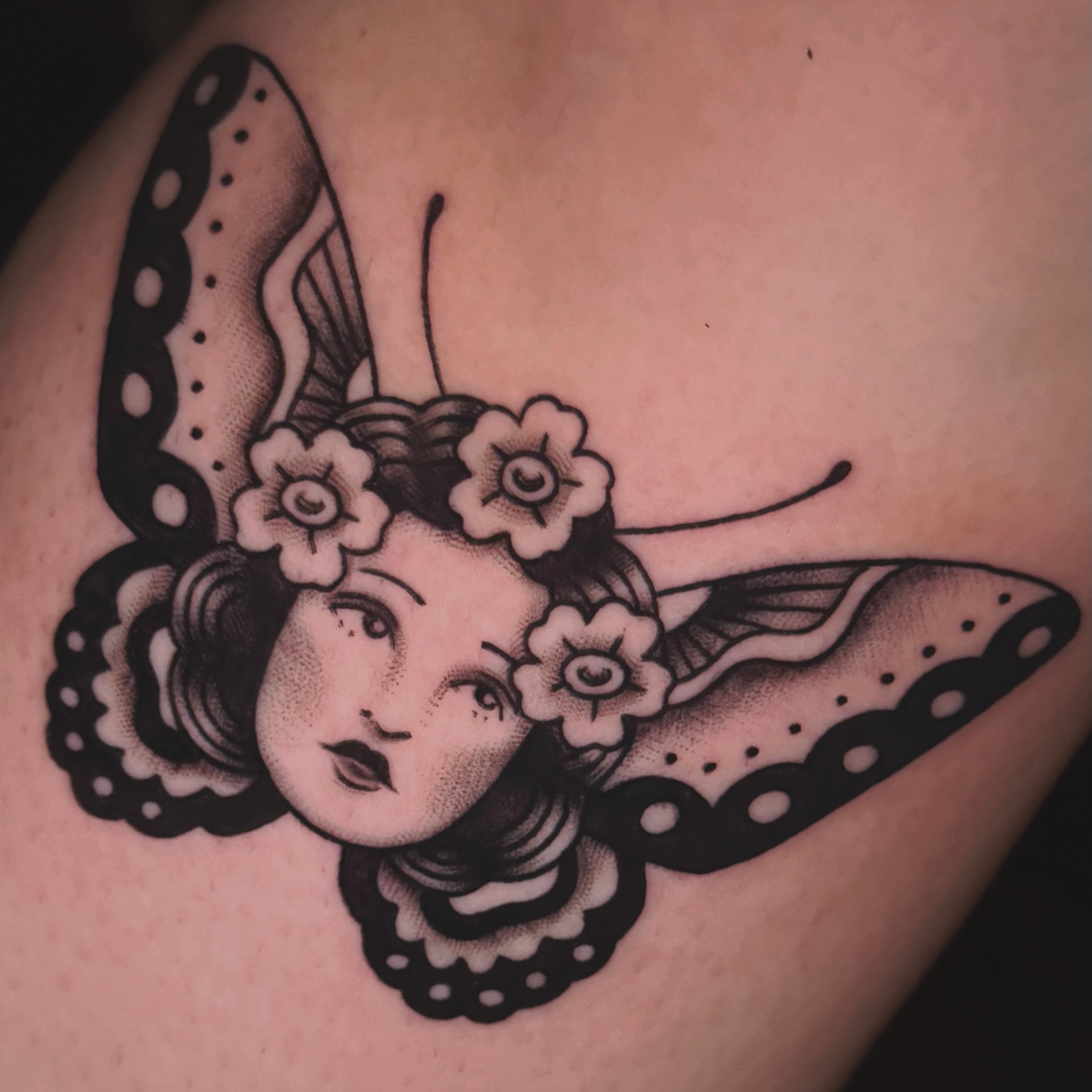 Butterfly and woman's face American traditional tattoo on the shoulder by Nikki Bee