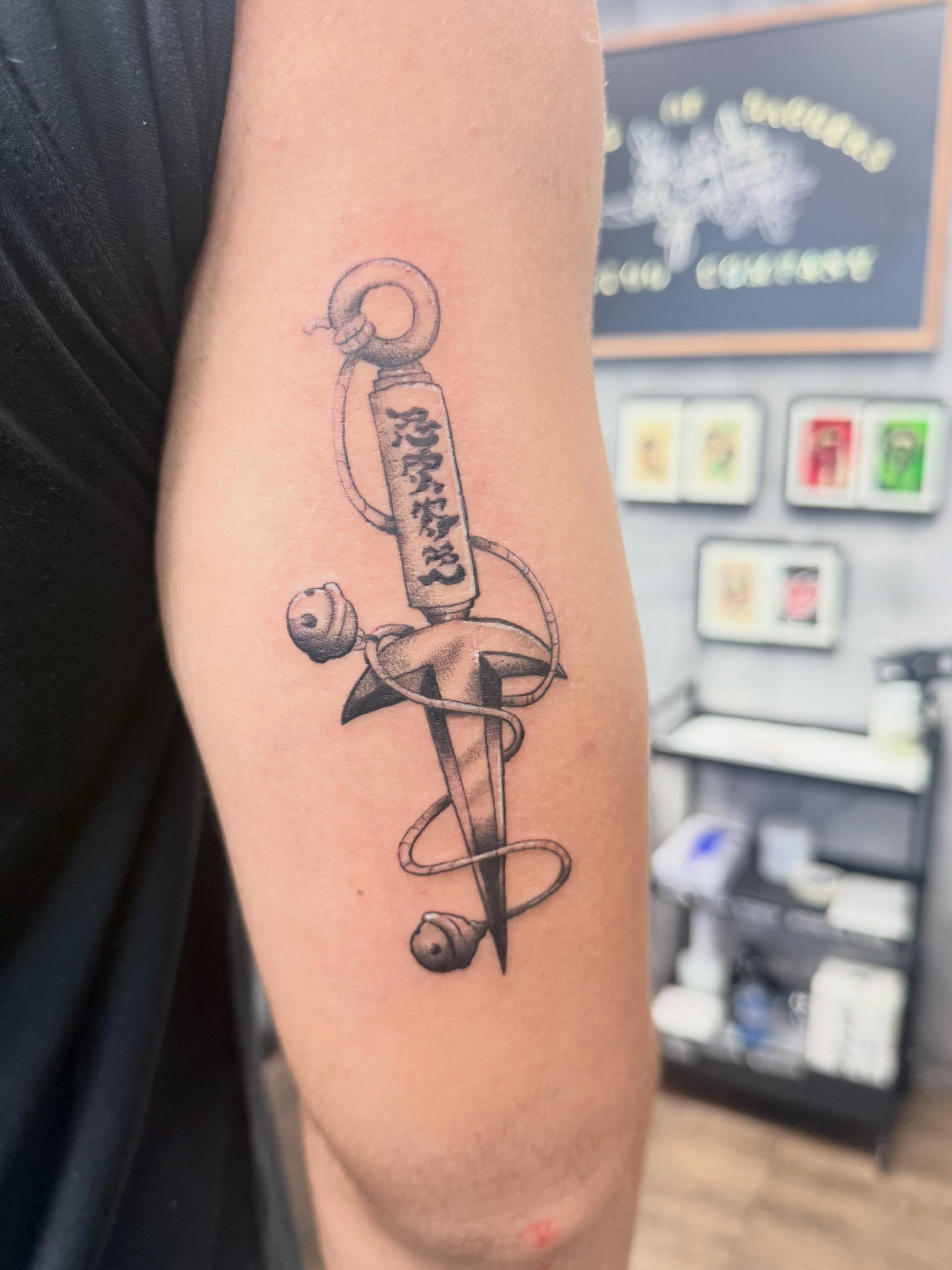 Sword and snake black and grey tattoo on the forearm by Chris