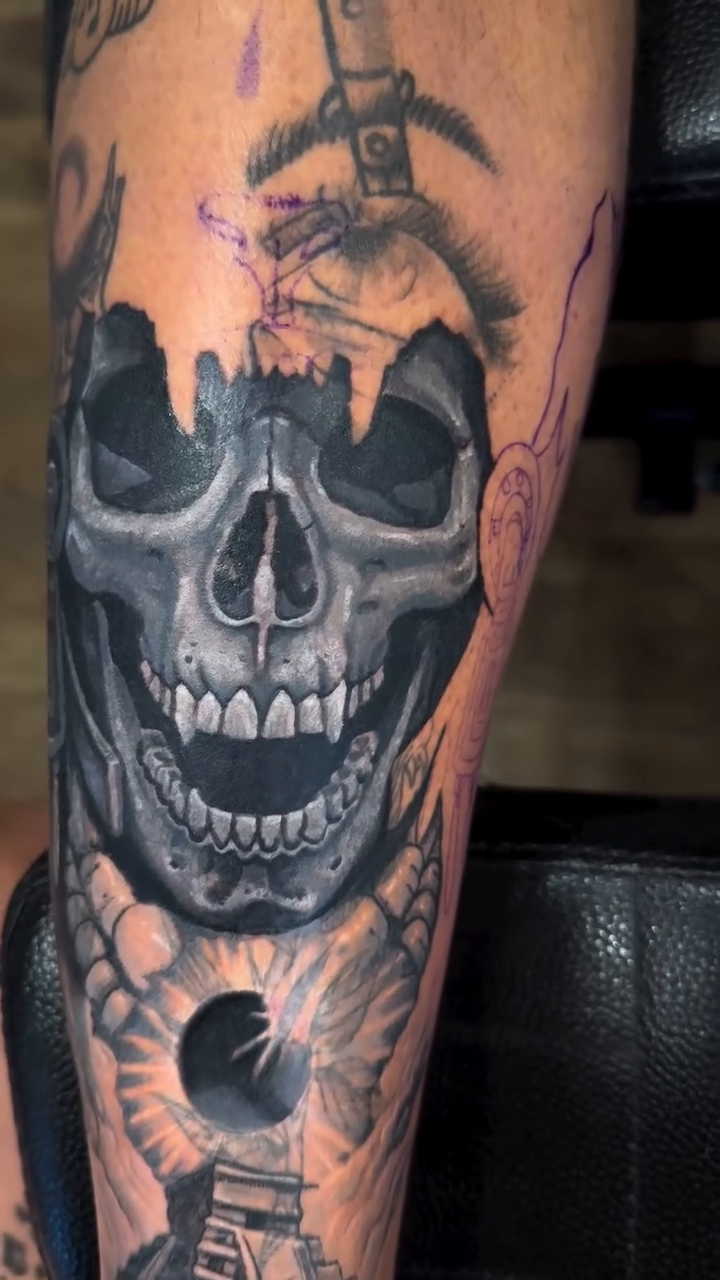 Skull with cityscape and bridge realism tattoo by Romi Utah Tattoo