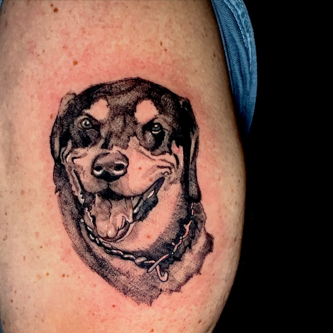 Dog realism tattoo on the upper arm by Evan Intveld