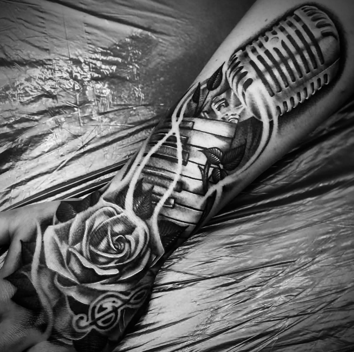 Microphone and rose realism tattoo on the forearm by Big Steve Lewis